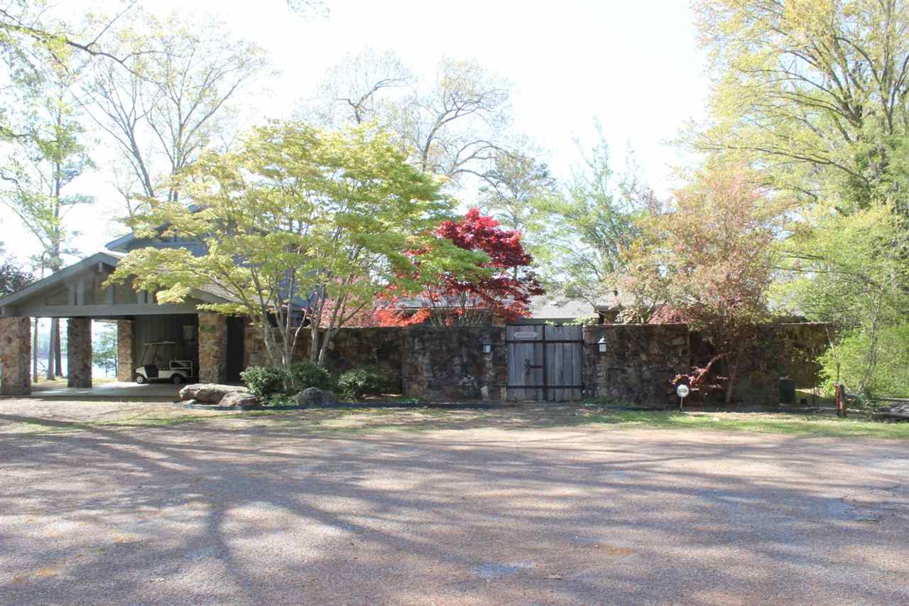 Eden Isle - LAKEFRONT, FURNISHED home with great privacy, an incredible location and spectacular lake views and lake access!!  Located at the northernmost end of Fox Chase Road, this home would be fantastic for a large family or a corporate retreat!  6 bedrooms (5 of which are suites with private baths!) spacious living with slate floors, tall ceilings and lots of glass, wonderful front courtyard with great landscaping, 2-car portico & golf cart garage, huge deck, large screened porch, close to EI Marina!
