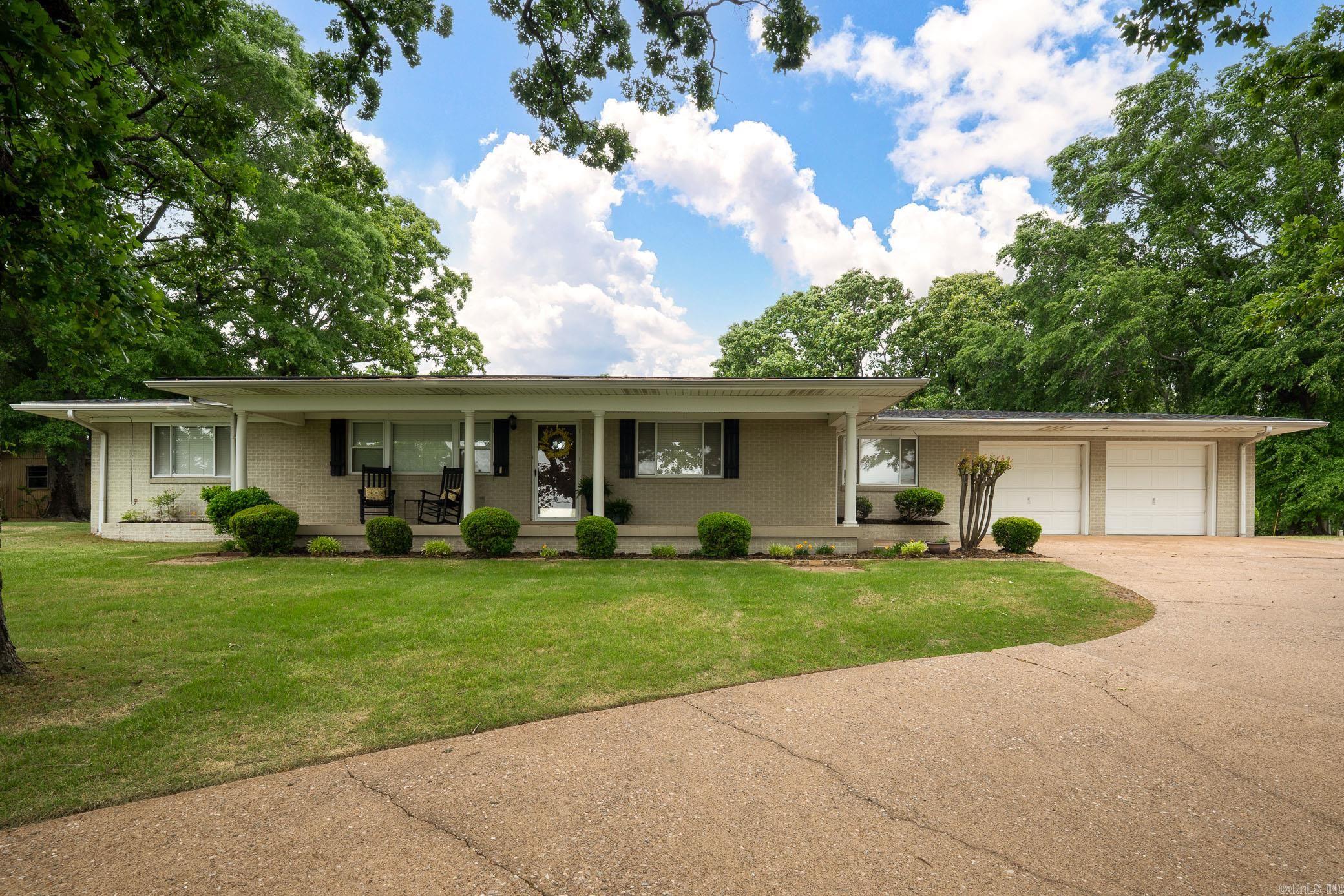 Perched in a prime location overlooking the city of Conway, this 4BR/2BA home has amazing scenic views & timeless character. From the front, enjoy sweeping city vistas, while the back reveals an even more stunning outlook of the large back yard & tranquil view of Lake Gentry—creating a peaceful setting perfect for morning coffee or unwinding in the evening. The front porch invites you inside where the home embraces its original vintage charm, with the opportunity to update & make it your own. The floorplan features a large living room with incredible city views, while the cozy den captures the beautiful lake scenery & access to a covered patio—ideal for relaxing or entertaining. True to its era, the home boasts generously sized rooms & great closet storage throughout. Recent updates include a new roof & hot water heater in 2025. A convenient circle drive enhances both curb appeal & functionality. Step outside to enjoy a nice backyard complete with a shop & shed for hobbies, tools, or extra storage needs. Ideally located, this home is close to dining, shopping, & minutes from the interstate. This property is a unique opportunity to enjoy breathtaking views with endless potential!