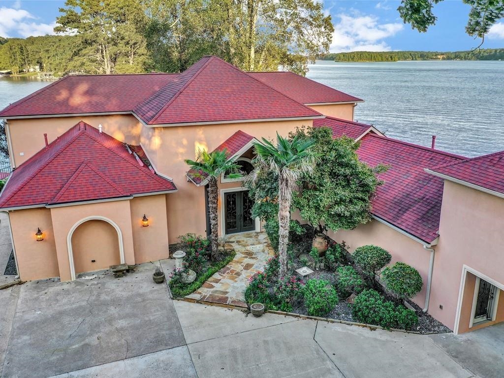 Standing prestigiously on the other side of a private gated entrance is a majestic Lake Hamilton mansion with all of the design details and amenities you could imagine.This incredible property is located on the most amazing prime waterfront ground, with uninterrupted views from both the ground and second floors.  This unique lot juts into the lake more than 450 feet, creating a private island feeling and is arguably one of the most unique point lots in the popular "7 South" area.