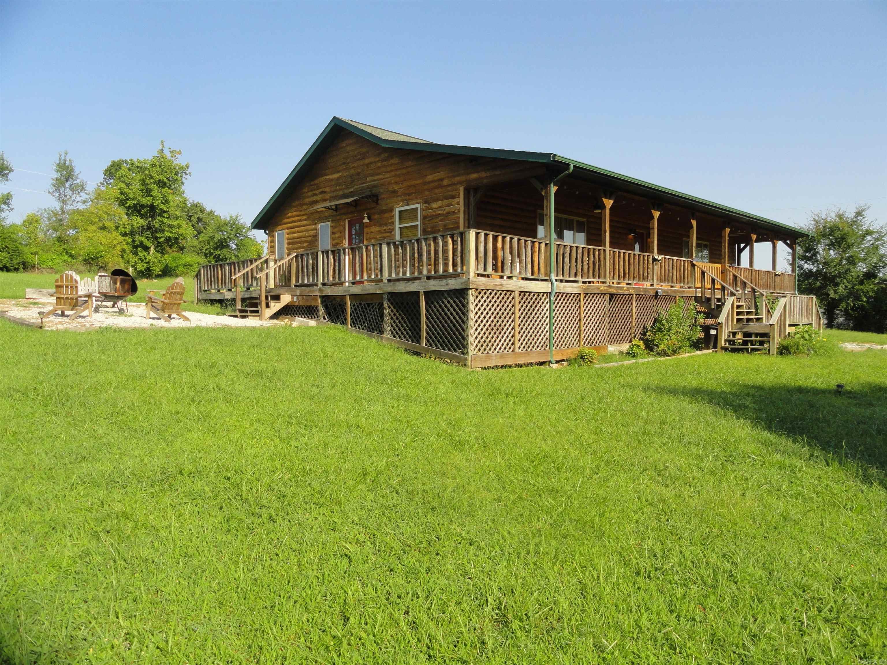 Established income producing Airbnb/VRBO business. Turn key opportunity, fully furnished & ready for vacation renters. This beautiful vacation rental cabin, known as “Buffalo Star Cabin” (look it up) comes completely furnished & has a great track record of consistent, year round nightly renters. This cabin is located just 3.6 miles outside of Saint Joe, AR & only 2 miles from Buffalo National River. Woolum Campground which is located on the banks of Buffalo National River is only 3.2 miles away and is a popular canoe/kayak “Put-in & Take-out” location with a gravel bar on the river. With an average of 800,000 visitors going to Buffalo National River yearly & no motels for miles and miles, it is easy to secure a share of the market due to the need of travelers looking for a place to spend the night. Not needing an income producing property? No problem. This cabin is move-in ready & fully furnished for your personal get-a-way or your forever home. This property is a 3 bed 2 bath, 1680 sq ft home that is beautifully decorated with a huge covered front porch, side deck 1.53 surveyed acres, beautiful yard and fire pit area. Searcy County is a great place to retire to, or raise a family.