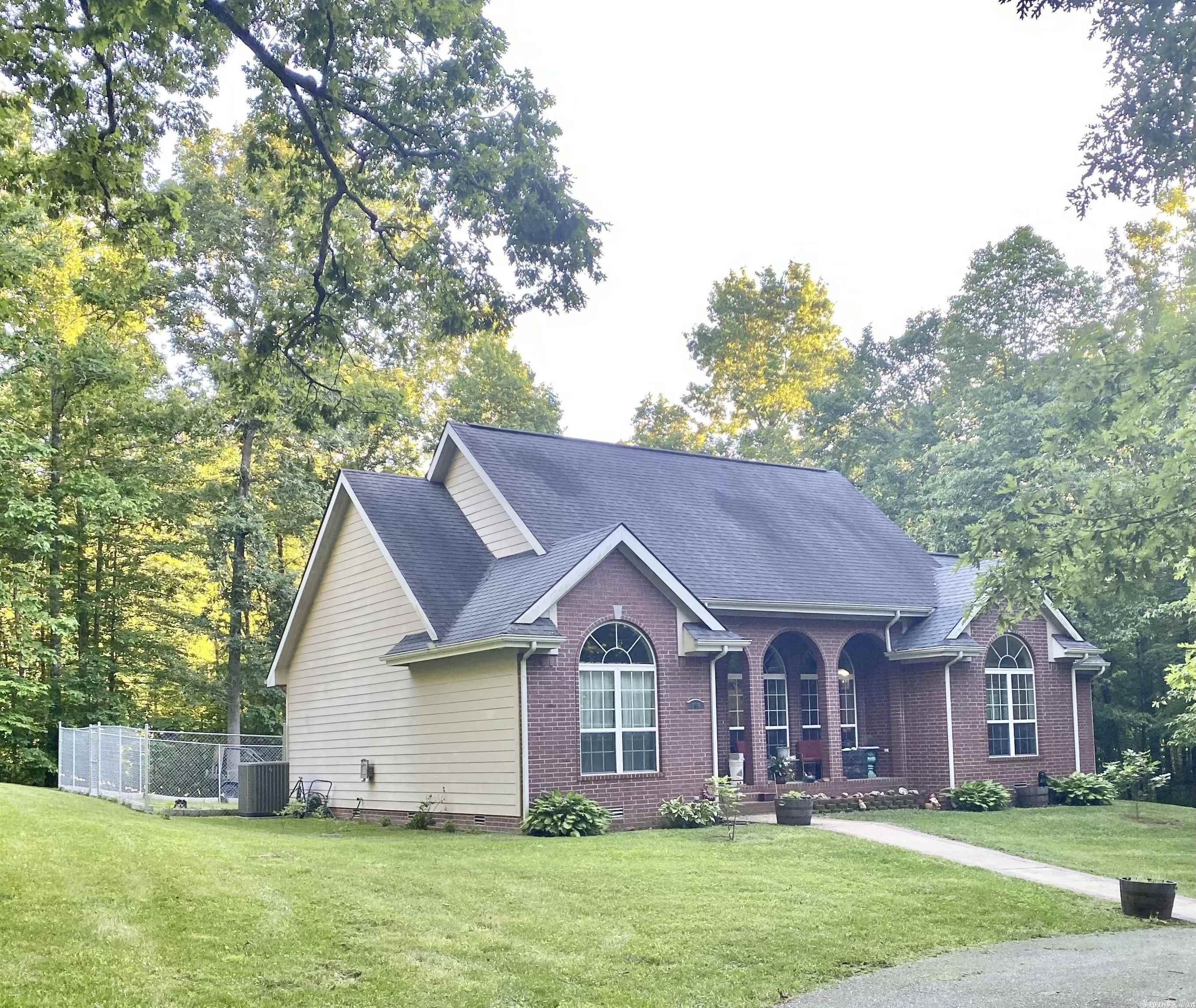Beautiful brick home with lots of character, from the circle drive, large arched porch and mature trees in the yard this place calls you home! Inside you see the stately architecture of the ceilings, windows from the foyer and large living room with gas log fireplace, you see high arches framing the formal dining room too! In kitchen there is a breakfast bar and eat in kitchen you can enjoy eating your breakfast while watching the great outdoors out each of the large windows, that let in so much natural light! There is attic space that is completely closed with wood walls, an oversized garage for all the storage space you could want, a She Shed and a hot tub for relaxing! The heating and air was completely replaced in 2019 with all new duct work too, Kitchen Aid appliances throughout kitchen new 2 years ago with a new farm sink and tile floors also! You have the feel of seclusion without a neighbor in site, but just minutes from town! Call and view this one today!