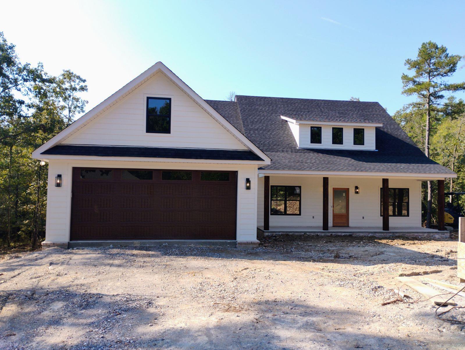 Welcome to this beautifully crafted, near completion construction in Hot Springs Village near the Glazypeau Road Gate giving you easy access to area amenities.  Thoughtfully designed for modern living, offers both style & function with upscale finishes throughout. 3 bedroom, 2 1/2 bath. 2 car garage in Fountain Lake School District. Step inside to an open-concept floor plan that flows seamlessly through the living, kitchen, and dining areas—perfect for entertaining or everyday life. The kitchen is a standout, equipped with a large slab granite island, walk-in pantry & abundant counter space. The spacious living area features vaulted ceilings, windows that bring the outside in to the living/dining area with fireplace that adds both charm & comfort. The split-bedroom layout ensures privacy, with primary suite offering a serene retreat. Enjoy his-and-her vanities with granite countertops, a luxurious oversized walk-in shower, deep soaking tub & custom walk-in closet complete the primary suite. Covered patio for nature watching. Schedule your private showing today. Agent is related to seller. Builder one year warranty. Taxes lot only. Agent Remarks.