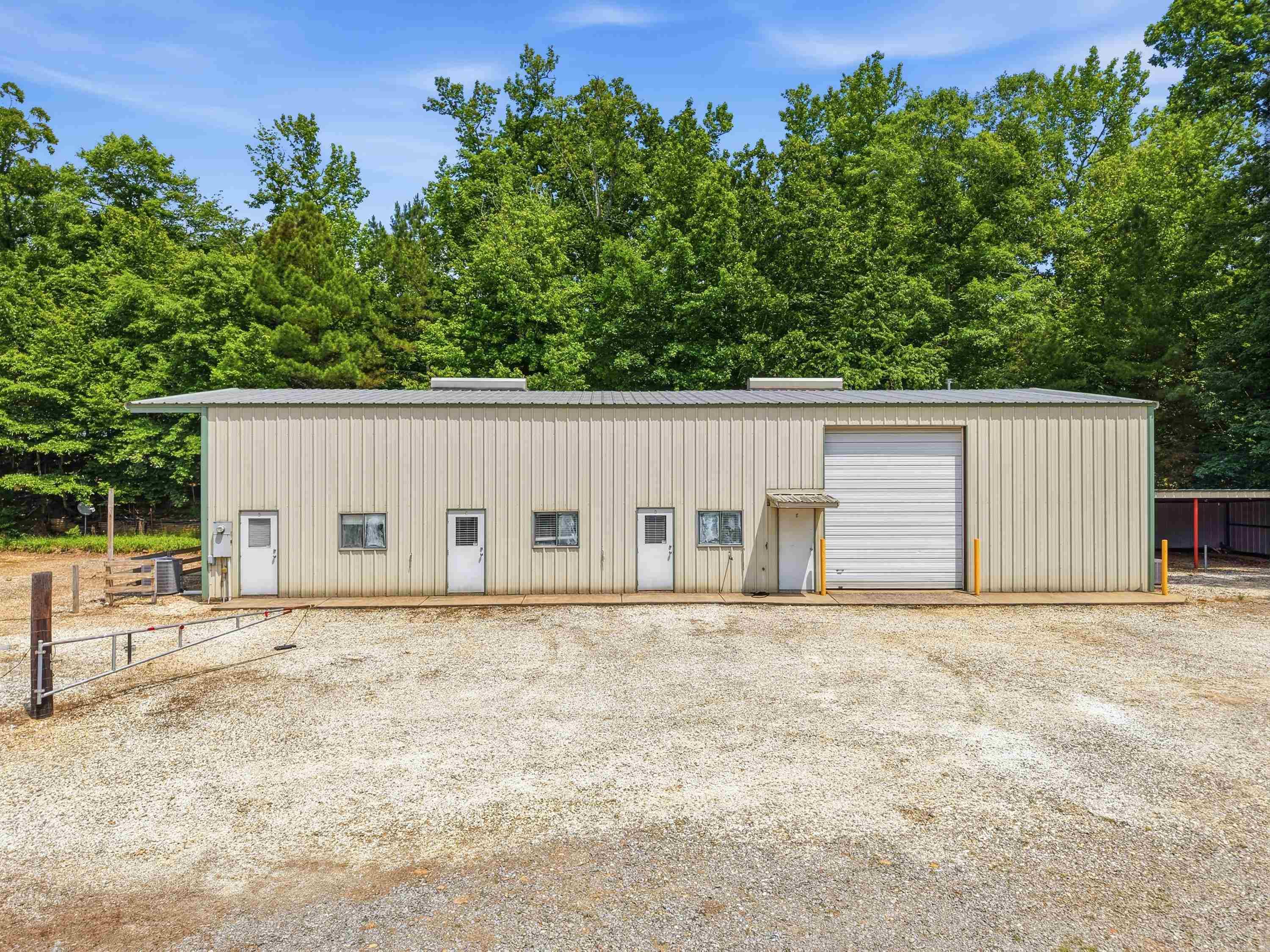This multi-functional 40x80 shop/business building. The spacious shop features 16-foot walls, a large 12x14 garage door, and is fully heated and cooled, making it ideal for year-round work or business operations. A 20x30 lean-to provides additional covered space for equipment, vehicles, or storage. The shop area also includes a ½ bath and an eyewash station, adding both convenience and safety. Above the shop, you'll find approximately 1,800 sq ft of floored storage with walk-up stairs, offering ample space for inventory, equipment, or future expansion. The business side of the building includes four offices, two of which were previously used as music studios, providing excellent sound-controlled spaces that could be repurposed for creative work, recording, offices, or additional living space. This side of the building also features a full bathroom and kitchenette, making it comfortable and functional for daily operations. With its flexible layout, this property is a fantastic opportunity for entrepreneurs, hobbyists, or anyone looking to create a custom barndominium-style living space with room to work and grow. Additional house & land for sale 4401 Peeler Bend Road MLS #26019696