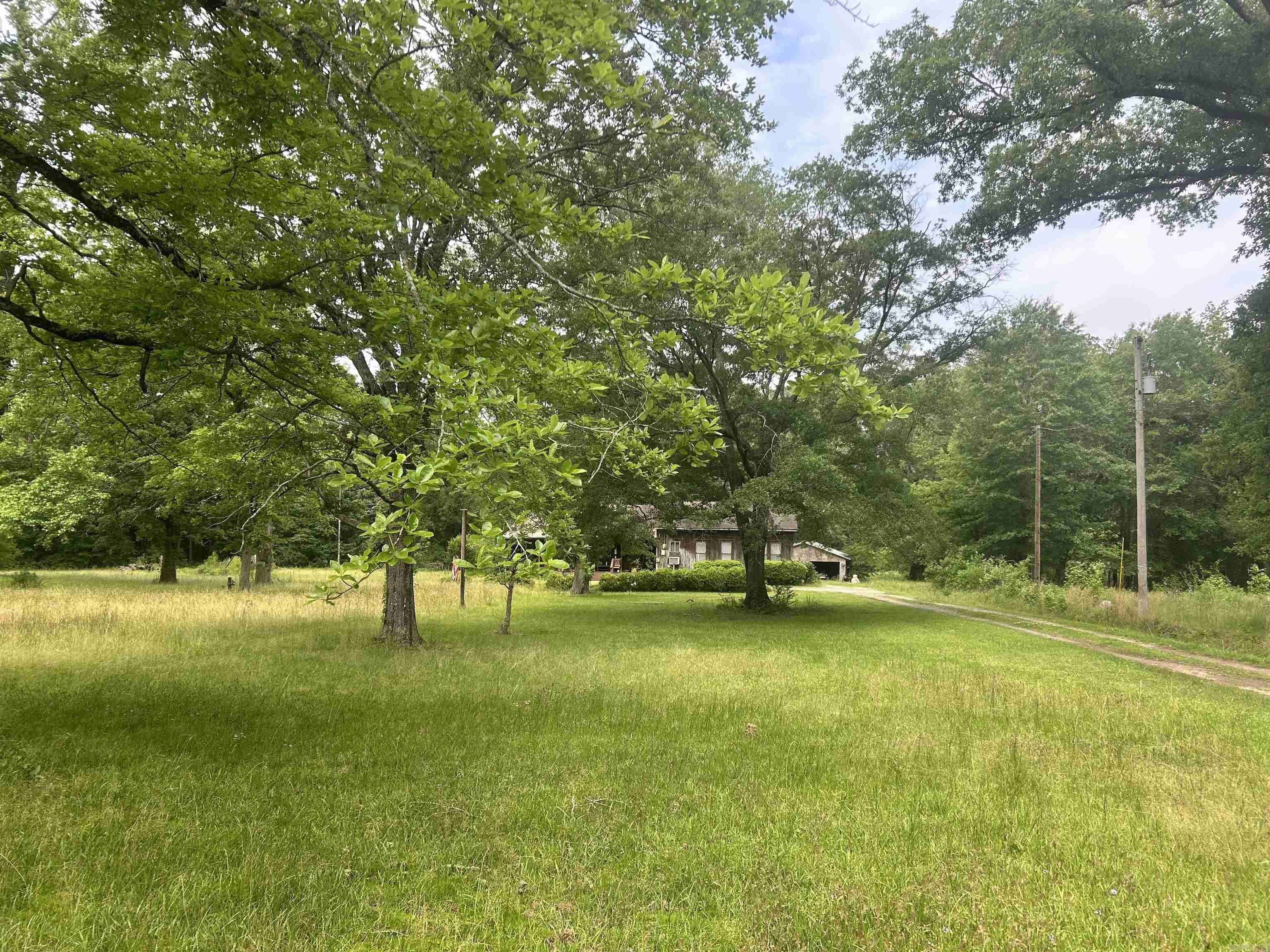 Country home sitting on 10.63 Acres just waiting for someone with great ideas.  Home is frame, high ceilings in living/dining combo and the kitchen.  The three bedroom have lower ceilings with lots of potential.  Must see this one to know the potential of what your imagination can do.  With some work, could be that beautiful country home sitting on 10.63 acres of land located just minutes from Crossett.  Home has a wood burning stove sitting on a brick hearth in the living area.  No central heat or air.  Beautiful and welcoming front porch.  One you must see.