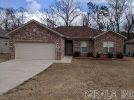 9ft Ceilings, 4" base, hard surface floors, laminate and tile through out except the master bedroom (carpet). 2" faux wood blinds, gutters on front and back, American Standard HVAC, cellulose insulation, attic space for storage. Refrigerator included. Extra green space that is wooded behind house.