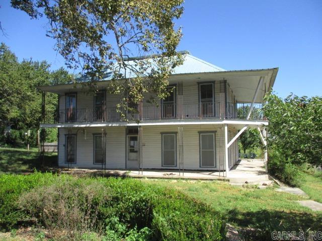 THIS UNIQUE TWO STORY 5 BEDROOM /2 BATH HOME FEATURES A LARGE CORNER LOT, A COVERED WRAP AROUND PORCH & BALOCONY. LOCATED IN THE CENTER OF TOWN, CLOSE TO THE LOCAL AMENITIES. PLENTY OF SPACE TO ENJOY.