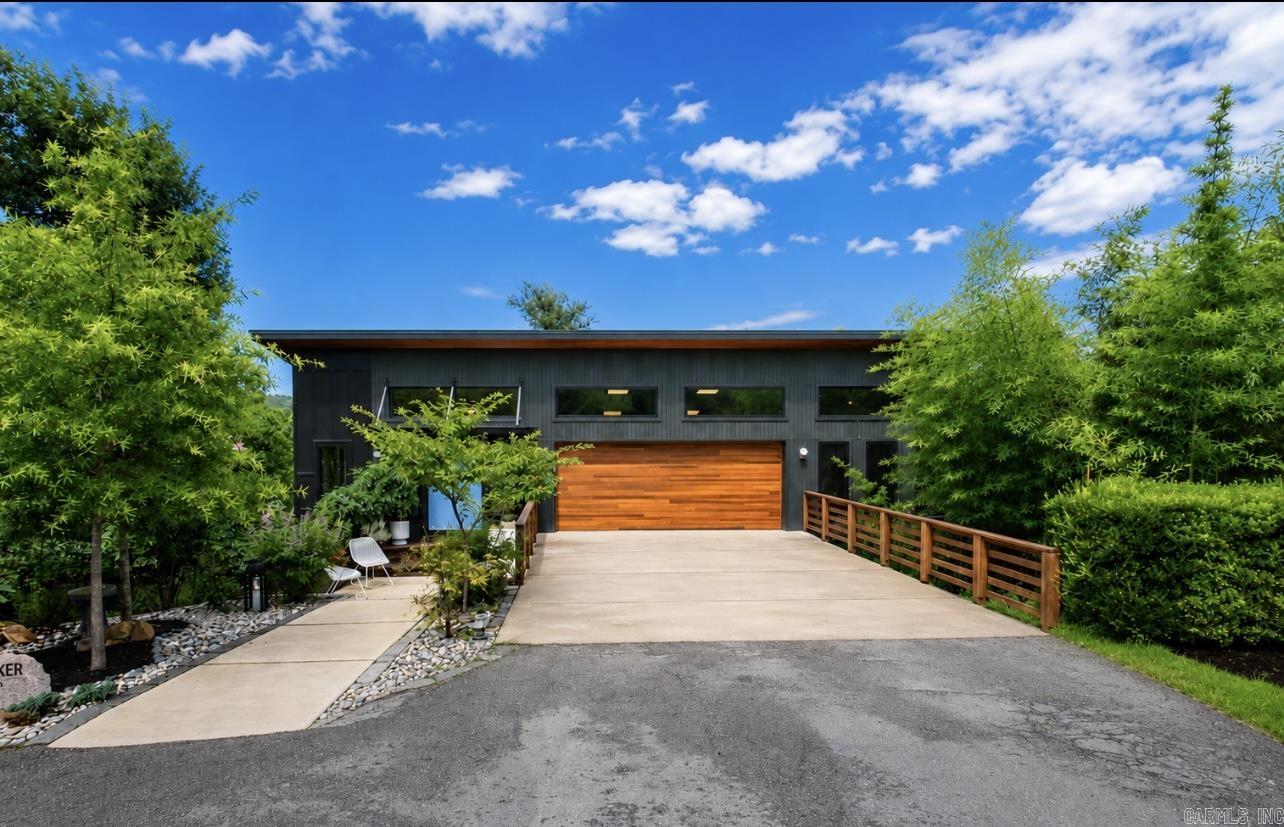 Exceptional Mid-Century Modern, completed construction in February of 2024, blending timeless architecture & luxury modern living in the heart of Kingwood.   You will love the open-concept living, dining + kitchen area ideal for entertaining & the dedicated office space.  Premium finishes include custom cabinetry, quartz countertops, a hidden pantry with professional-grade refrigerator, designer fixtures, luxury flooring & high-end appliances that blend with the home's aesthetic. This home features a primary bedroom with large walk-in closet + ensuite bathroom with soaking tub & walk-in shower, a second bedroom with a fully updated guest bathroom & a third bedroom that is also suited for a media room.  Enjoy seamless indoor-outdoor living with a main-level deck & expansive wraparound deck overlooking lush landscaping & a peaceful natural green space.  The insulated 2-car garage offers ample storage + room for a home gym or workshop.  A rare opportunity to own a fully reimagined Mid-Century Modern home with top-of-the-line craftsmanship, energy-efficient construction & a private setting on the end of a peaceful cul-de-sac. The attention to detail is unmatched. Call to see today.