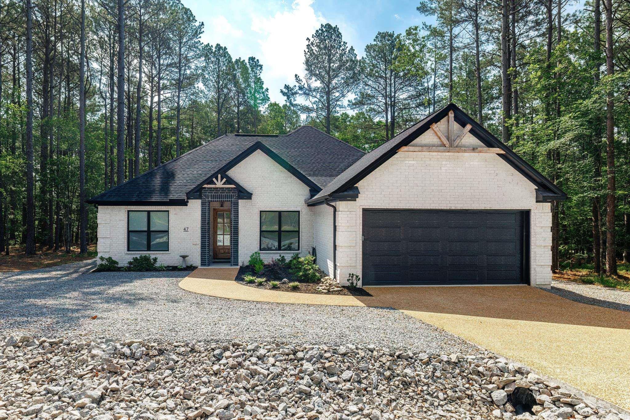 Discover your dream home in the heart of Hot Springs Village! This exquisite all-brick craftsman-style residence offers the perfect blend of modern elegance and comfortable living. Situated on a level lot in a serene neighborhood just minutes from the West gate of HSV, you'll enjoy convenient access to restaurants and shopping.    Step inside to find a thoughtfully designed open floor plan that bathes in natural light, ideal for hosting gatherings and creating memorable moments. The inviting foyer leads to a cozy living room, complete with a gas fireplace that adds warmth and charm to the space.  The gourmet kitchen is a chef's delight, featuring sleek granite countertops, an oversized pantry, and high-end appliances. Luxury Vinyl flooring flows throughout the home, enhancing its contemporary appeal.  This split-plan home boasts 3 spacious bedrooms and 2.5 pristine bathrooms, both equipped with walk-in showers and a soaker tub. The primary suite is a true retreat, offering a walk-in closet that conveniently connects to laundry room.  Additional highlights include a versatile bonus room, perfect for a home office or playroom, and an oversized two-car garage providing ample storage.