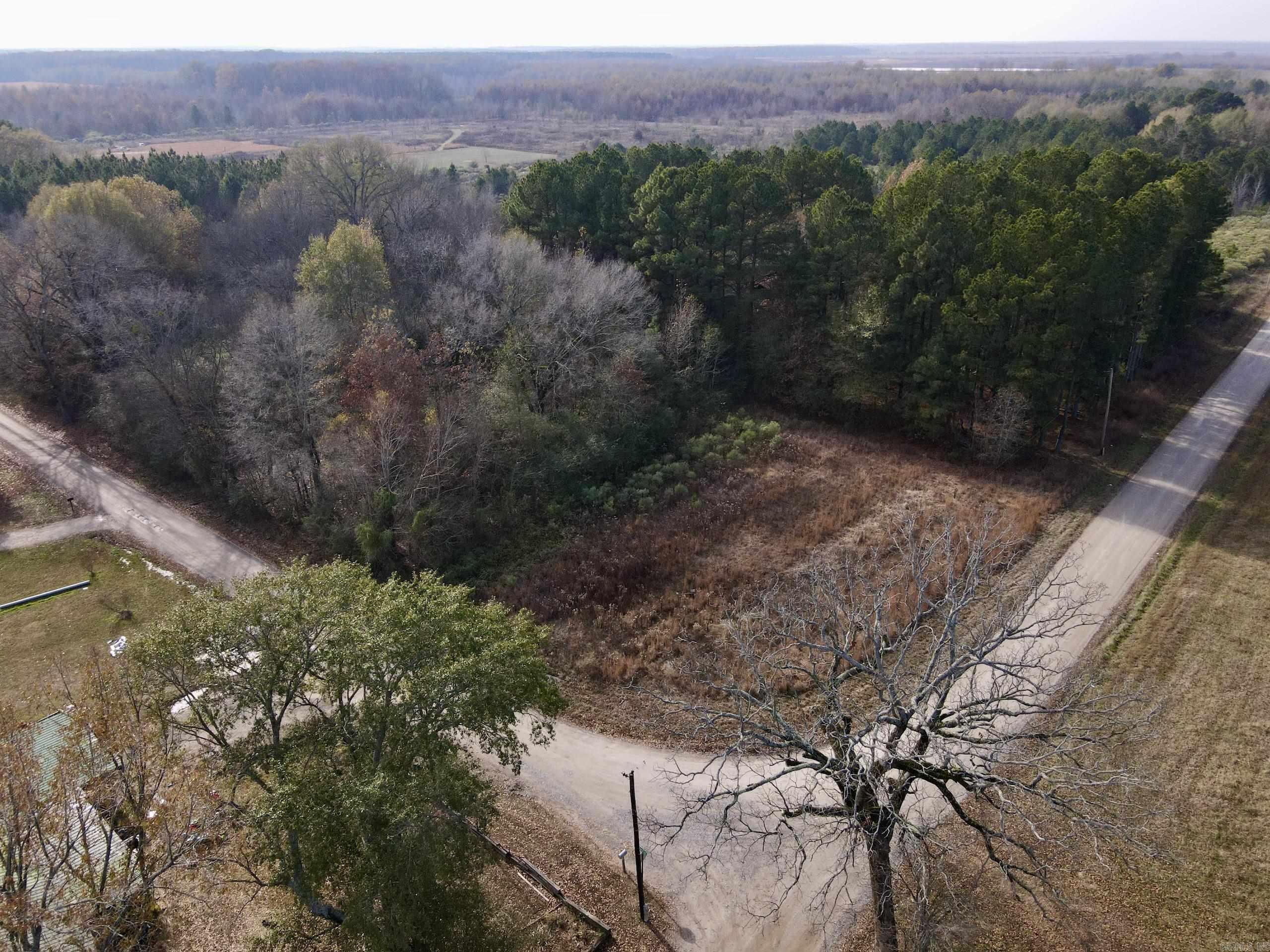 Located just 1.5 miles from the Bald Knob National Wildlife Refuge and 2 miles from the Henry Gray/Hurricane Lake WMA, this property offers a rare opportunity to build the perfect base camp for Arkansas deer and duck hunting in one of the state’s most productive wildlife regions. With the Henry Gray/Hurricane Lake WMA boat ramp only 5 miles away, you’ll have quick access to thousands of acres of flooded timber, wetland habitat, and world-class waterfowl hunting. The property features county road frontage on two sides, with electricity already available, making it ideal for building a hunting cabin, barndominium, or even multiple structures. The layout also creates excellent potential for dividing the acreage to offset your investment or develop family or partner camps. An old homeplace framed by mature pine timber provides a scenic building site with natural shade and character, while the rest of the land is fairly level and suitable for clearing into additional pasture, food plots, or new building sites. The area is surrounded by established hunting clubs, adding to the outdoor atmosphere and making it a great fit for sportsmen who value privacy, access, and year-round recreation.