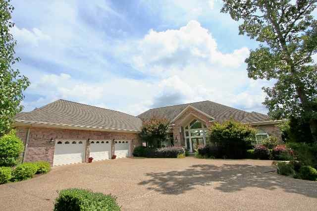 This 4-BR + study, 3-Bath treasure has custom cabinets throughout the house with Granite countertops in kitchen, Large custom designed brick see-through fireplace, lots of built-ins, panoramic view of lake and mountains. Complete with professional landscaping, a huge tiled patio, massive garage with lots of storage and work area, lighted seawall, sprinkler system and covered boat dock with entertainment area and much more. A MUST SEE!!