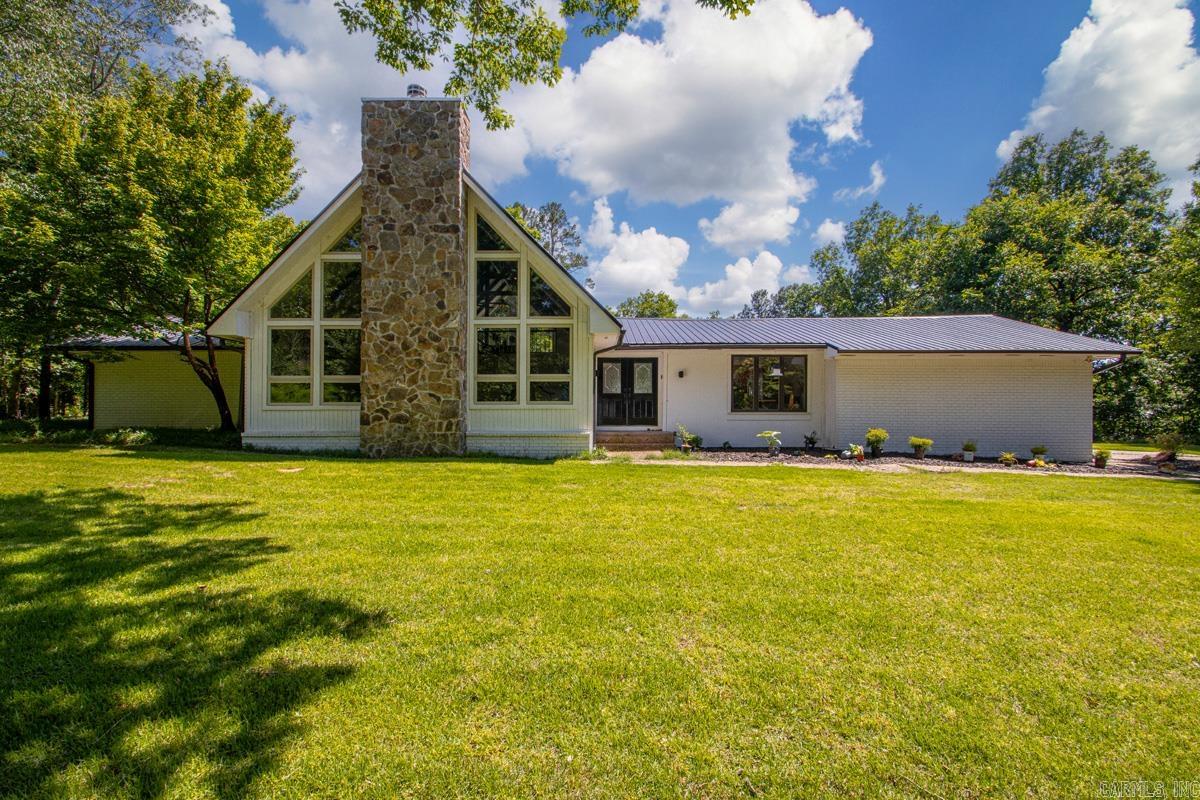 Open House June 14, Sunday, 2-4! Tucked away on 3+ serene acres in heart of WLR, one-of-a-kind property blends contemporary style w/exceptional amenities. Primarily 1-level has a stunning 2-story vaulted great room filled w/natural light & is showcased by expansive walls of glass flanking the rock FP. Gamerm/office overlooks salt-water pool through glassy vaulted views as well. Lg primary BD offers living space w/automated wall curtain providing private retreat. Remodeled primary bath (2020) offers a fresh, updated place to relax! Outdoor living space shines w/saltwater pool, cabana w/gas line for on-demand fire pit ambiance! Pool house w/tile shower, lg storage room & covered area for hot tub. Major updates: metal roof (2021), solar panels (2021), main HVAC (2026), secondary HVAC (2018), pool pump (2021), pool sand filter (2022), pool motherboard (2026), tankless recirculating hot water tank (2022). 16x20 workshop w/power. Minutes from Chenal Parkway, Kroger & Promenade & in Pulaski county, a once in a lifetime opportunity to own land plus enjoy convenience, privacy, thoughtful landscaping & abundant wildlife in a location that simply doesn't exit much any more! Your oasis awaits!