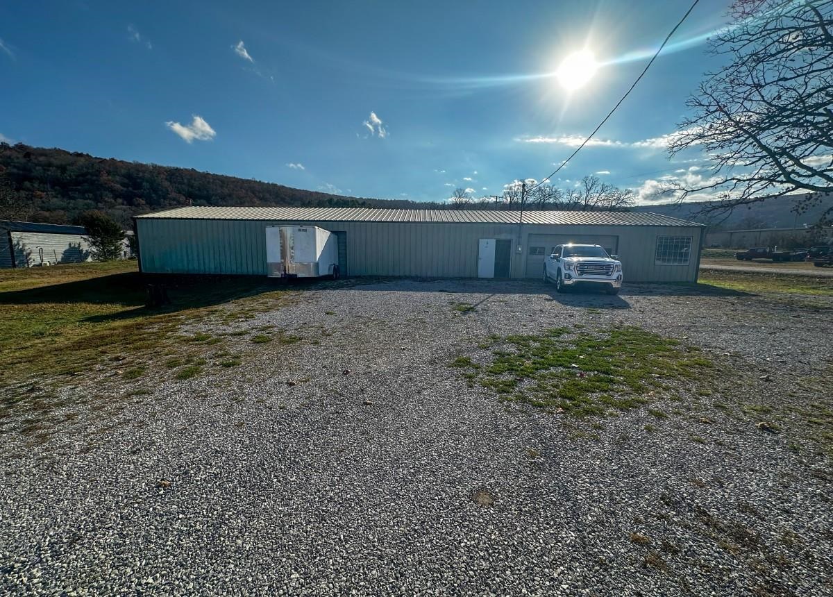 Prime Commercial Opportunity on West Main Street! Discover exceptional potential with this .93-acre corner lot located just outside the Mountain View city limits. Featuring a 3,000 sq ft metal building, this property is currently operating as a cabinet shop and is well-suited for a wide range of commercial, light industrial, or workshop uses. The building offers excellent functionality with a large garage door, convenient walk-through doors, and  office space. A paint booth and large exhaust fans will convey, providing valuable infrastructure for woodworking or similar trades. Additional perks include radiant floor heat and a half bath and a separate office space enhancing comfort and usability throughout the year. Situated on a high-visibility corner lot, this location offers outstanding exposure for your business with room for parking, expansion, or outdoor storage. Offered at $275,000.  Contact me today for more information or to schedule a viewing!