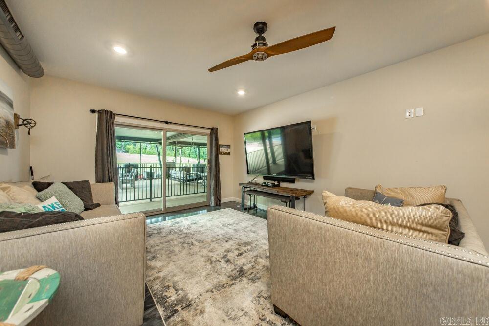 Suite 101 - First-floor unit in the Narrows Inn, one of nine lakefront condos offered at auction. This industrial-rustic 2 bed / 2 bath condominium (~1,181 SF) is built for entertaining with stained concrete floors, exposed ductwork, warm wood accents, and a built-in wine bar with cooler; pool views from the primary suite and guest bedroom. Kitchen features a live-edge wood bar top, Frigidaire stainless appliances, and solid-surface counters. Primary suite with sliding glass doors to the pool deck, walk-in closet, and double-vanity bath with large walk-in shower; guest bedroom and hall bath offer quality finishes. Pantry/laundry with GE stackable washer/dryer and barn-style doors. Offered through the Buyer’s Ultimate Choice auction with SOLDasap - bid on a single unit, any combination, or purchase all nine condos as a portfolio. Visit soldasap.com or call 870-236-6117 for full terms and conditions.