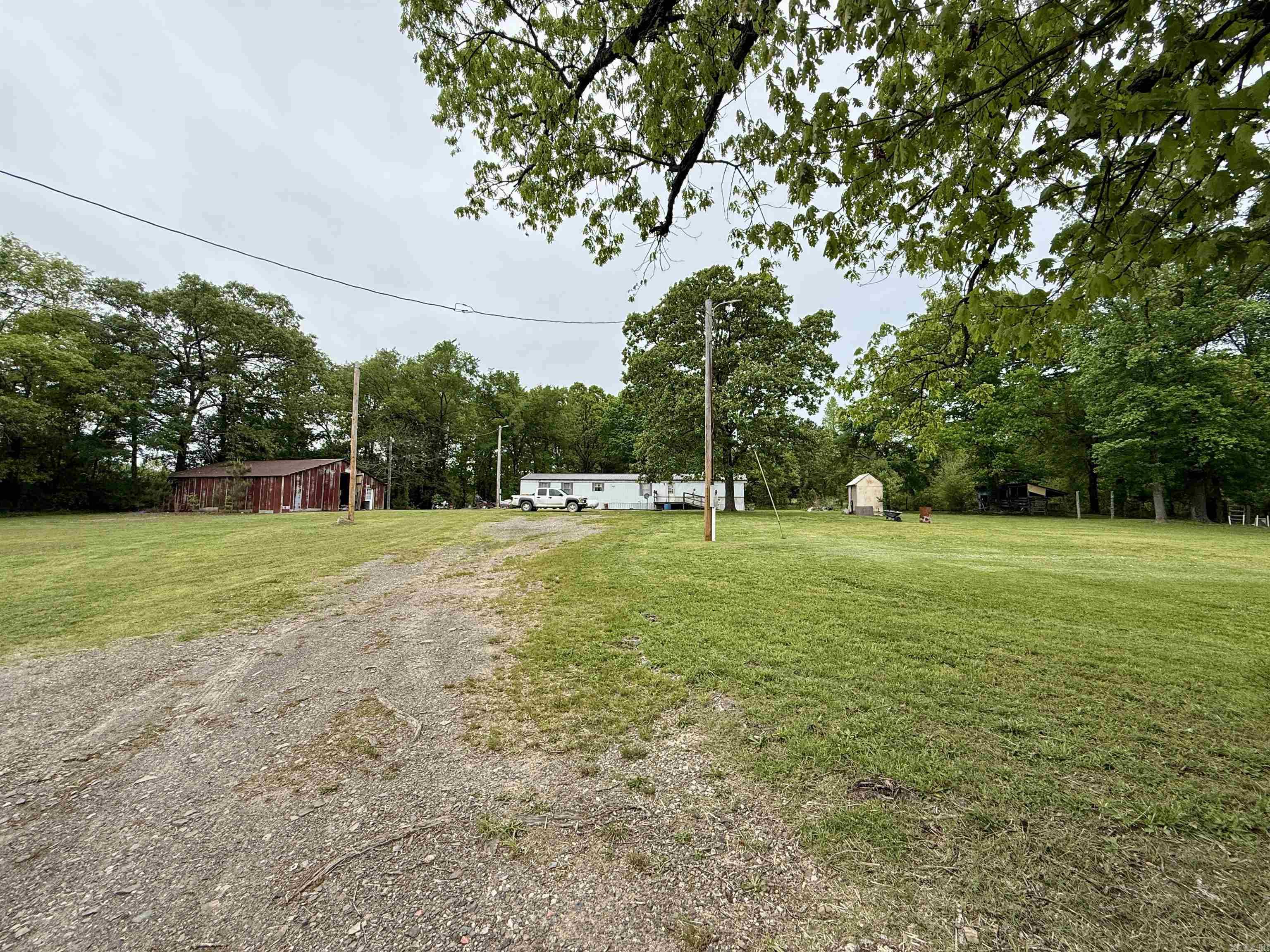Country living at its finest, and priced to move. This 3 bedroom, 2 bath single wide sits on over 2 acres and is ready for your personal touch. The property offers a huge shop, livestock pens, fruit trees, extra power pole for RV, and a well-maintained yard with plenty of room for a garden, small homestead, animals, or simply enjoying the quiet country life.  If you have been looking for peace, space, and affordability, this one checks the boxes. Located at 618 Polk Road 24 in Cove, Arkansas, this property offers the kind of quiet setting most people only dream about, and it is priced low and firm for a quick sale.