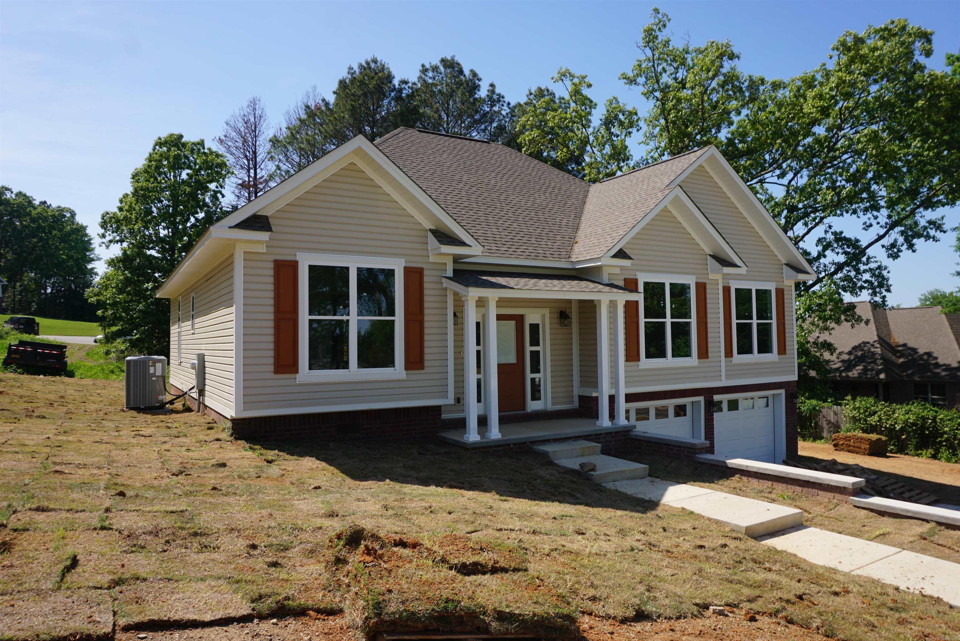 Beautiful new construction in West Searcy within walking distance to the Elementary school, Harps, and so much more. Nice entry into the house with multi level easy walking sidewalks, pretty front porch that opens into a nice foyer. The large living room is open to the kitchen/dining room, all with very pretty, neutral flooring. There are stainless steel appliances, and the custom built cabinets offer so much storage, and the granite countertops are beautiful. The house has a very open light and neutral vibe throughout. The laundry room also has custom built cabinets. The primary suite and 1 bedroom are on 1 side of the house with the en suite having a double vanity, soaking tub, walk in shower and large walk in closet with built in shelving and multi level hanging rods.  The other 2 bedrooms and a full bathroom each having their own private room with a vanity off the shared bathroom. There is a custom shoe closet at the front entry and a 1/2 bath conveniently located off of the living area. The double garage has room for a workbench or storage. The covered back porch is so nice and the yard has just been sodded. Taxes are land only from the courthouse records.