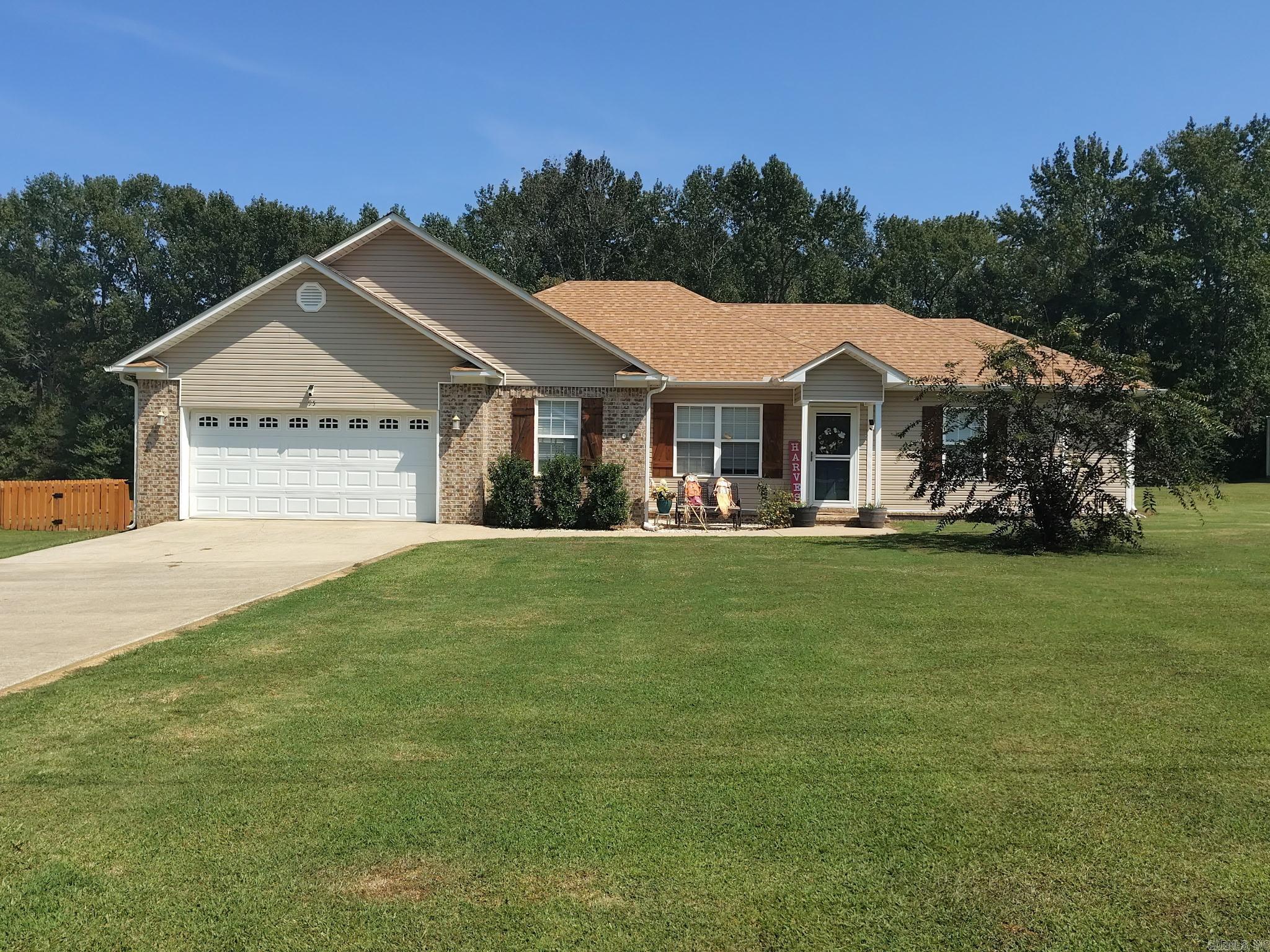 Nicely updated 3 bedroom, 2 bath home with 2 car garage with well over an acre yard. Spacious yard includes privacy fence, patio, chicken house, 18' above ground pool & a 20x20 shop with 2 rollup doors. The yard goes into the trees at the back for privacy. Kitchen remodel includes new granite countertops, new sink & faucet & new dishwasher. Several shiplap accent walls around the house, new laminate flooring in living room & halls. The garage has a recently installed Mini split to regulate temperature & the architectural roof was replaced in 2024 & the water heater was replaced in 2023.  It also features gutters, a tray ceiling in living room & a separate laundry room. Appointment only.
