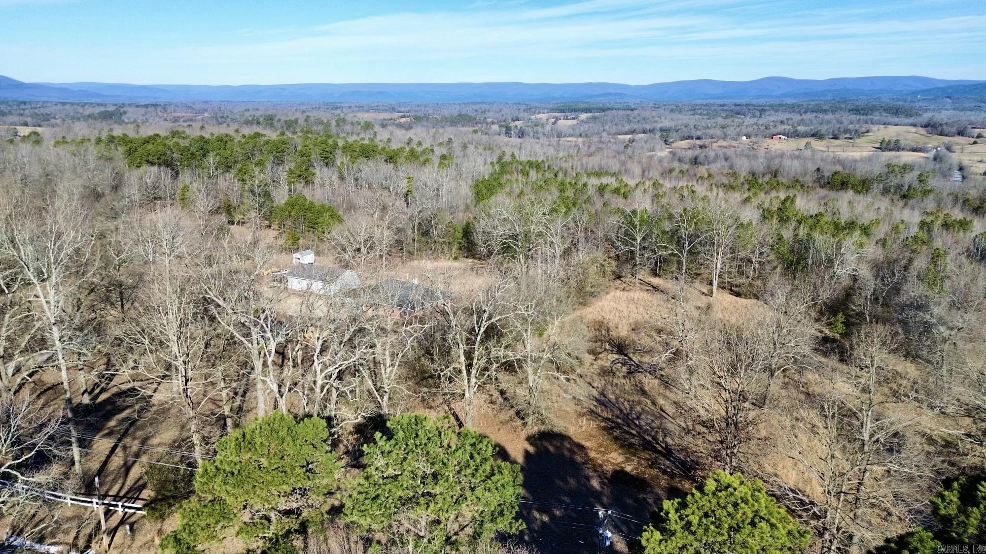 Beautiful 10.73 acres located just outside of Mena! There is a 3/2 mobile home on the property that could be fixed up or used as storage and a large 30x50 insulated shop with bay doors. Nice building spot at the top of the hill with gorgeous mountain views! Utilities are already on the property for your convenience. This property is on a paved road and close to the bike trails that will be coming to the Mena area. Perfect location to build your home or vacation rental! AGENTS SEE REMARKS