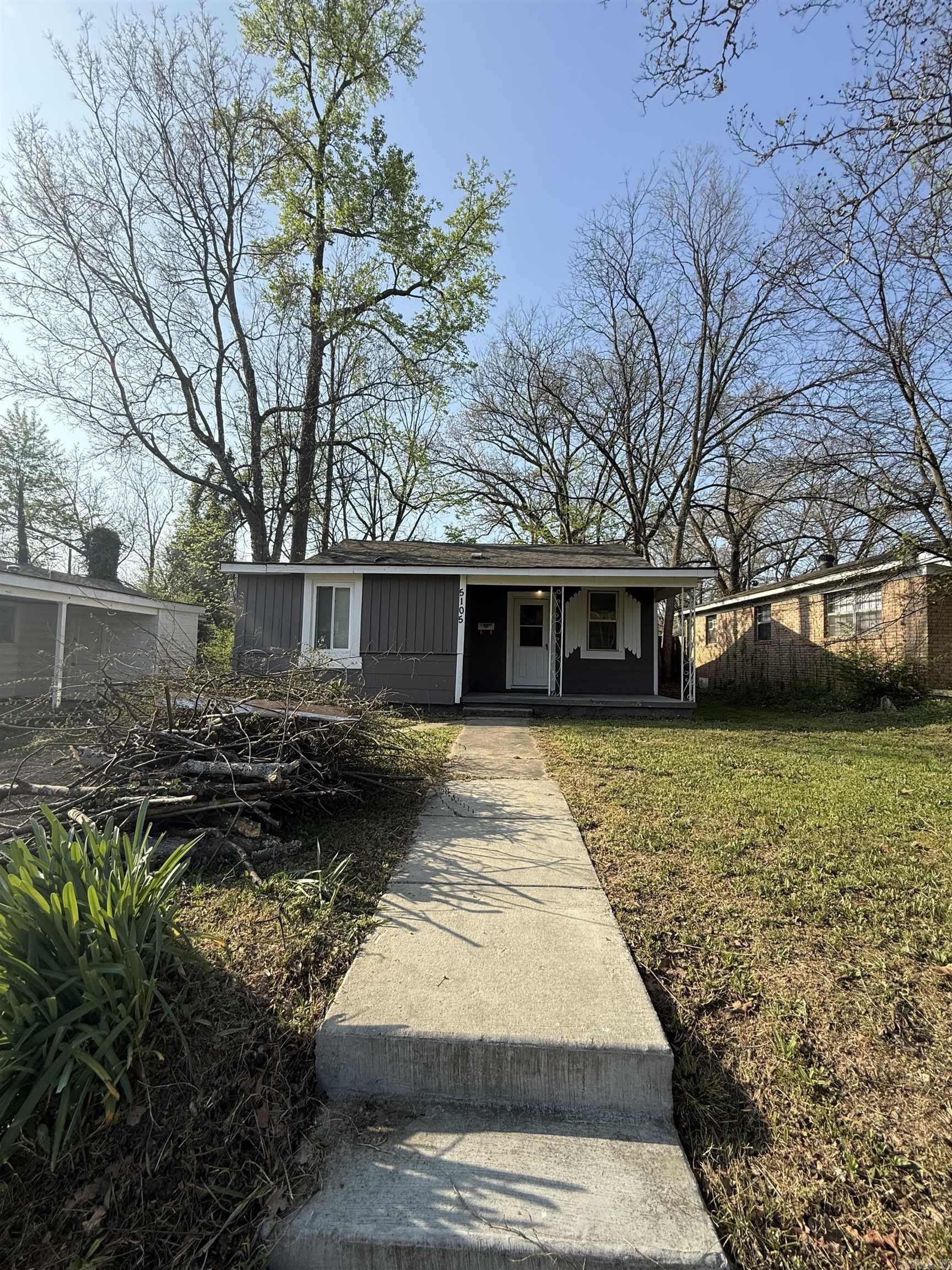 Character and convenience meet in this 2-bedroom, 1-bathroom traditional home located in the established Boulevard Terrace community. Spanning 1,036 square feet, the interior features classic hardwood and new flooring throughout, a cozy fireplace, and an eat-in kitchen designed for functional living. The property sits on a level 0.14-acre lot with a private patio, offering a manageable outdoor space for relaxation or entertainment. This residence is exceptionally well-placed for students and professionals, situated just down the street from the University of Arkansas at Little Rock (UALR).