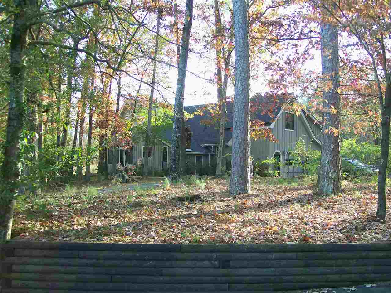 SILENT AND SECLUDED! RETREAT TO THIS RUSTIC 4 BEDROOM ON 46 ACRES WITH ITS ROCKING CHAIR SCREENED FRONT PORCH, MASSIVE STONE FIREPLACE, COUNTRY KITCHEN WITH COZY HEARTH ROOM, PECAN CABINETS, CORIAN COUNTERS, THE CUSTOM WOODWORK IS UNBELIEVABLE, FLAGSTONE ENTRY HALL, BUILT-INS GALORE, BIG WORKSHOP, WONDERFUL DECKS, OFFICE, CLOSE TO LAKE OUACHITA AND LAKE HAMILTON.  THIS IS A WONDERFUL SETTING OF PEACE AND QUIET!