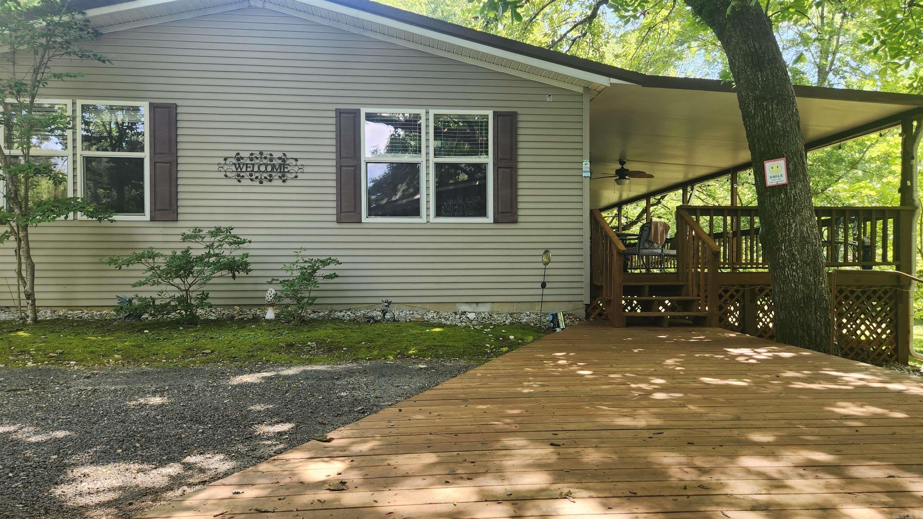 3 bedroom 2 bath with 1764 sq ft living space. Built in 1998 manufactured home with a few recent updates....granite counter tops, tile in bathrooms, and laminate flooring through out. Fully furnished. There is a 12x13 bonus room off the large back deck (41x14). Metal roof. 2 car carport, "fish hut" 15x17, 12x24 storage building, concrete block basement/storm shelter. 20 kw Generac generator. Mount Ida City water. Just minutes to Mountain Harbor or Shangri La's access to Lake Ouachita. Home is located in Joplin Trailer Park and yard maintenance is included. Give us a call for your private viewing.