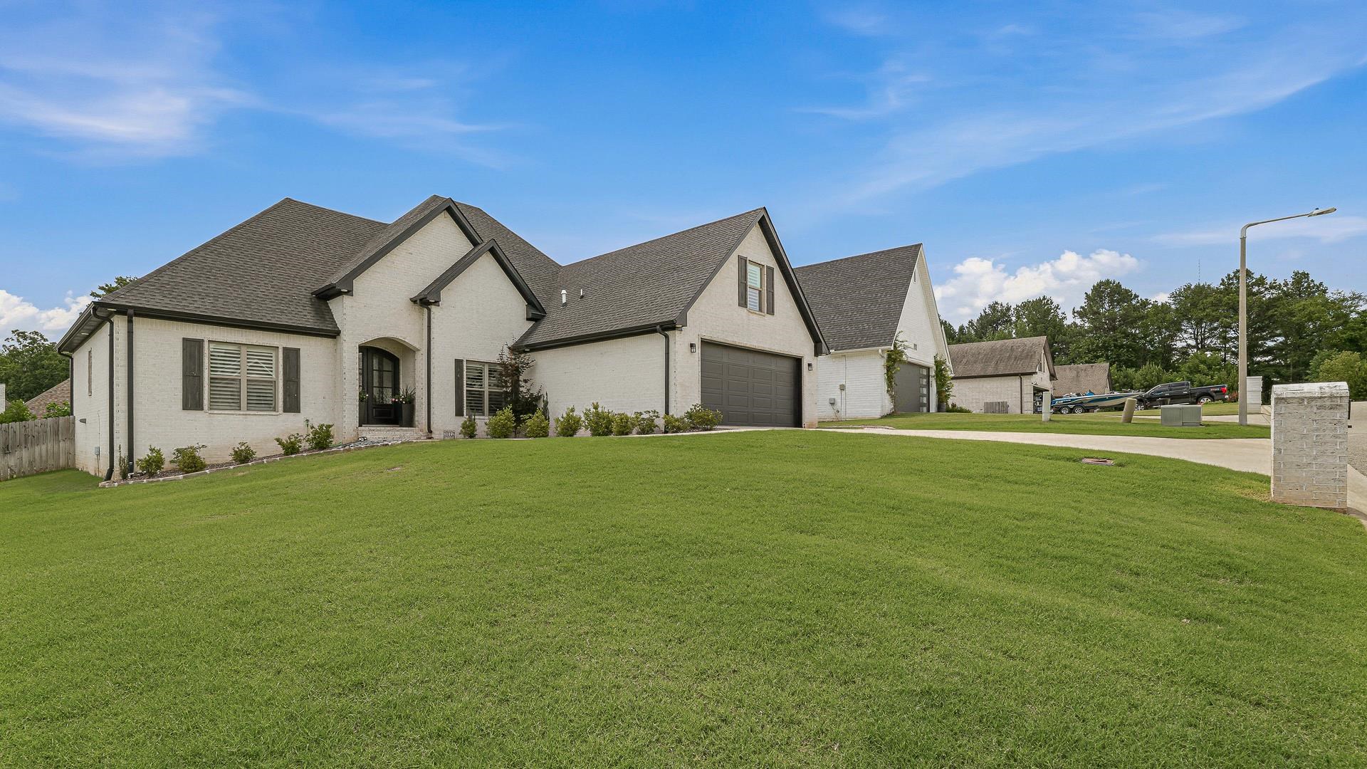 Beautiful 4BR/3.5BA home in the desirable Harrison Hills subdivision and Valley View School District! This thoughtfully designed floor plan features three bedrooms on the main level, including a spacious primary suite, plus a private fourth bedroom with a full bath upstairs—ideal for guests, a home office, or flex space. The open-concept living area offers abundant natural light, soaring ceilings, plantation shutters, and a gas log fireplace. The kitchen features a large island, stainless steel appliances, ample cabinetry, pantry, and a breakfast area perfect for gathering with family and friends. The primary suite offers a tiled walk-in shower, soaking tub, dual vanities, and a generous walk-in closet. Enjoy the screened porch overlooking a professionally landscaped backyard featuring privacy trees, decorative rock, a custom stone pathway, and extensive drainage improvements. Recent updates include a new mini-split system, smart home features, fresh paint, and enhanced outdoor living spaces. A tankless gas water heater, laundry room with sink, lawn sprinkler system, and two-car garage complete this move-in-ready home with thoughtful upgrades already in place.