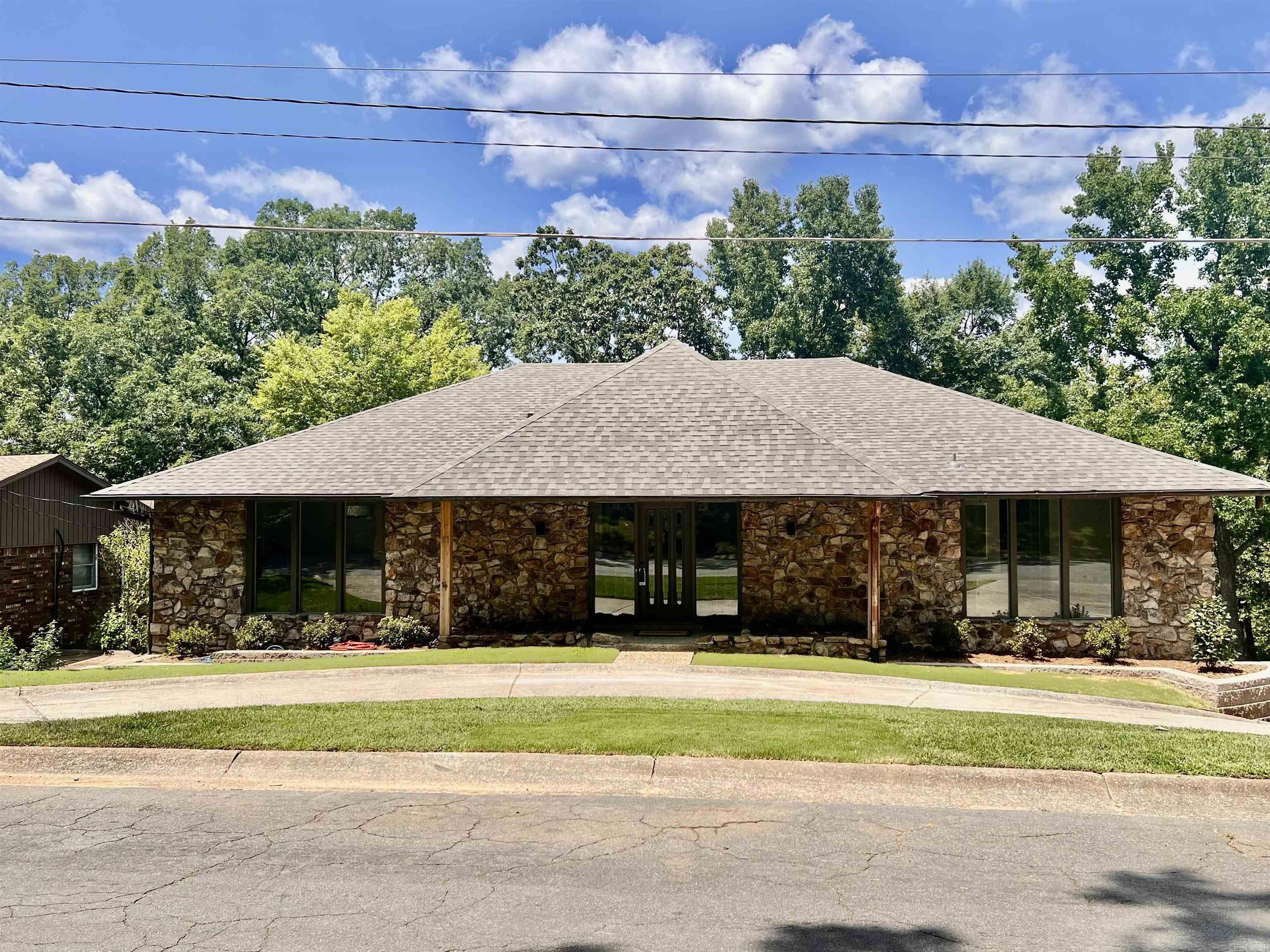 BY NO FAULT OF THE SELLER, HOME IS BACK ON THE MARKET! Lakefront living at its finest! This beautiful 4BR, 3.5BA, 4,111 square foot home spans two stories with two spacious living areas and spectacular views of Lake No. 2! The den has vaulted ceilings with wooden beams and a cozy woodburning fireplace and a very special bar area! Roof, flooring, siding, decks and landscaping all new this year! New paint throughout the home and all bathrooms have updates as well!  There is ample storage throughout the home and it even has two laundry chutes! There is a two car covered carport in the back of the home, with room to park many more cars, as well as a circle drive in the front of the home. There is also a saferoom! Home sits on a quiet cul-de-sac and is close to all amenities. Must see to appreciate all this home has to offer!