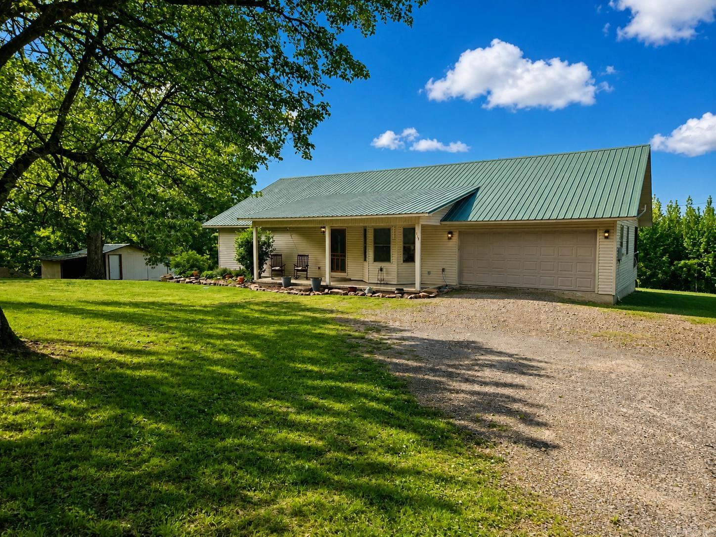 Private and peaceful, this 3.28-acre hobby farm is located just minutes from Greers Ferry Lake and a short drive to Clinton. The property includes a 60x120 riding arena, 900 sq ft barn, pond, chicken coop, garden shed, and RV pad, offering plenty of space for livestock, hobbies, or outdoor activities. The home features 3 bedrooms, 2.5 baths, 1,555 sq ft of main living space, plus an additional 752 sq ft of finished basement area for extra living space and 785 sq ft of basement space for storage, recreation, or a workshop. A covered porch overlooks the quiet, park-like setting, while the 2-car garage adds everyday convenience. With open space and a functional layout, this property offers a comfortable country setting with room to enjoy a variety of uses and activities.