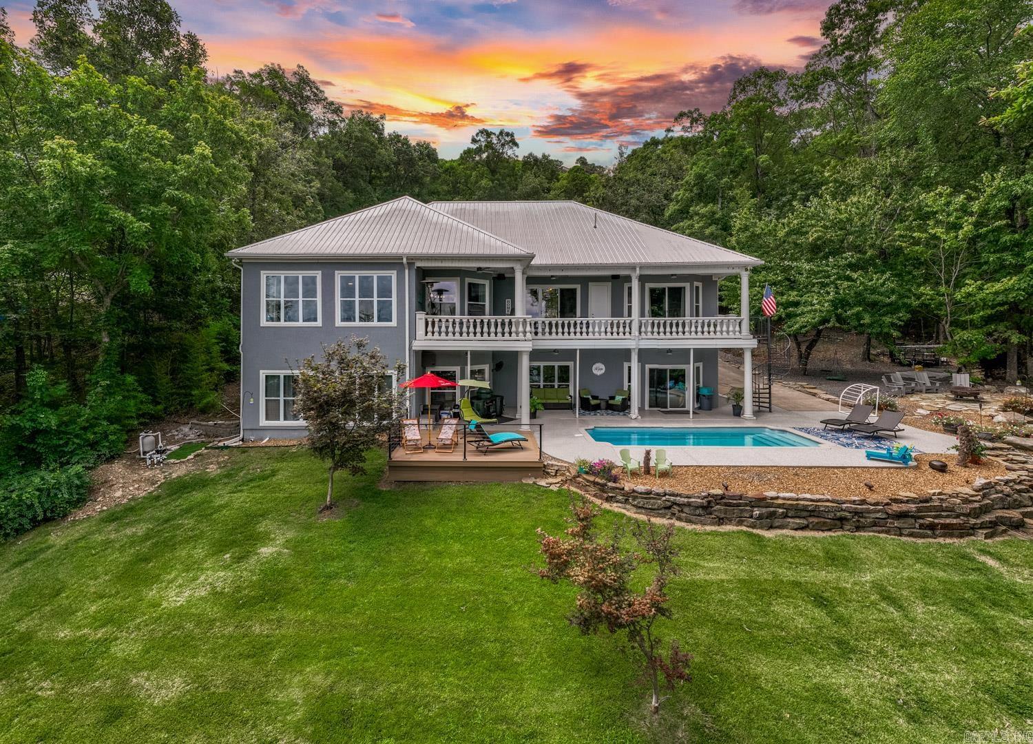 STRONG rental history for this beauty with over $70,000 in bookings so far for 2026, you will find this exquisite LAKEFRONT property offers the perfect blend of elegance & comfort & gorgeous lake views. Features 6 large bedrooms & 3 full baths, plus 3 half baths, this residence ensures ample space for both family & many guests. The chef’s kitchen is equipped with top-of-the-line appliances, sleek countertops, & custom cabinetry. The home features high-end finishes throughout, including luxurious flooring, stylish fixtures, & expansive windows that capture stunning lake views. Enjoy outdoor living at its finest with an in-ground salt water pool, & multiple entertaining areas with a fire pit perfect for hosting gatherings or relaxing in style.The property includes a convenient circle drive for easy access & ample parking. More great features include a whole home generator & Sonos sound system inside/outside. Whether you're seeking a peaceful retreat or an entertainer's paradise, this lakefront home on Greers Ferry Lake offers the ultimate in luxury living. There is also a 2.49 vacant lot next door that could be included as a package deal!!!  This home truly has it all!