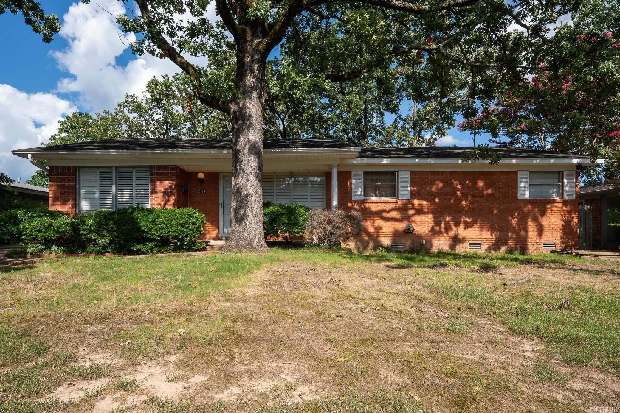 Charming and move in ready in the highly sought after Park Hill area of North Little Rock! This updated one level home offers 3 bedrooms, 2 full bathrooms, multiple living spaces, and a flexible layout that gives you room to spread out. Inside you’ll find original hardwood floors, fresh paint, granite countertops, and a mix of modern updates with timeless character.  The spacious bonus room makes a perfect second living area, game room, home office, or playroom, while the sunroom provides a bright and relaxing space overlooking the backyard. Outside, enjoy a fenced yard, covered parking, and additional storage or workshop space.  Conveniently located near downtown North Little Rock, shopping, restaurants, parks, and schools, this home offers both comfort and convenience in an established neighborhood. Qualifies for 100% financing for eligible buyers. Come see everything this Park Hill home has to offer!