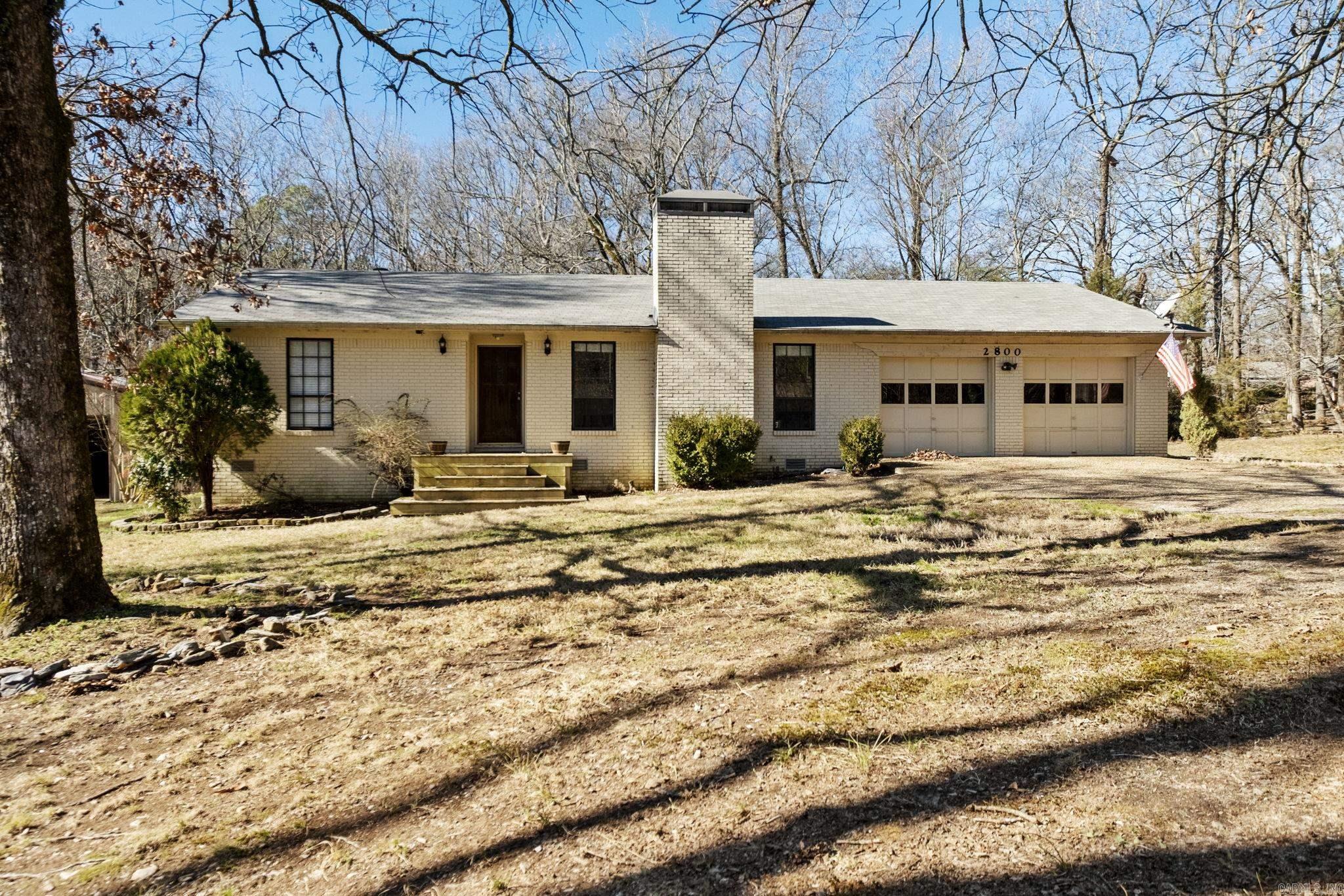Country living close to the city! Enjoy your best life on this 2.56 acre property with a stocked pond! This home boasts a spacious living room with a wood burning fireplace and pretty laminate flooring. The eat-in kitchen features a stainless electric stove with ceramic cooktop and a stainless refrigerator. The dishwasher is newer and has only been used a few times. There is also seating at the breakfast bar.The primary suite includes a full bath with tub/shower. The guest rooms share a hall bath with tub/shower. There is a half bath located off the kitchen and large laundry room. There is a screened in deck along with a large wood deck for entertaining. The well is no longer in use. The septic system was pumped and cleaned this year. The shop has electricity and built in work benches. Agents See Remarks.