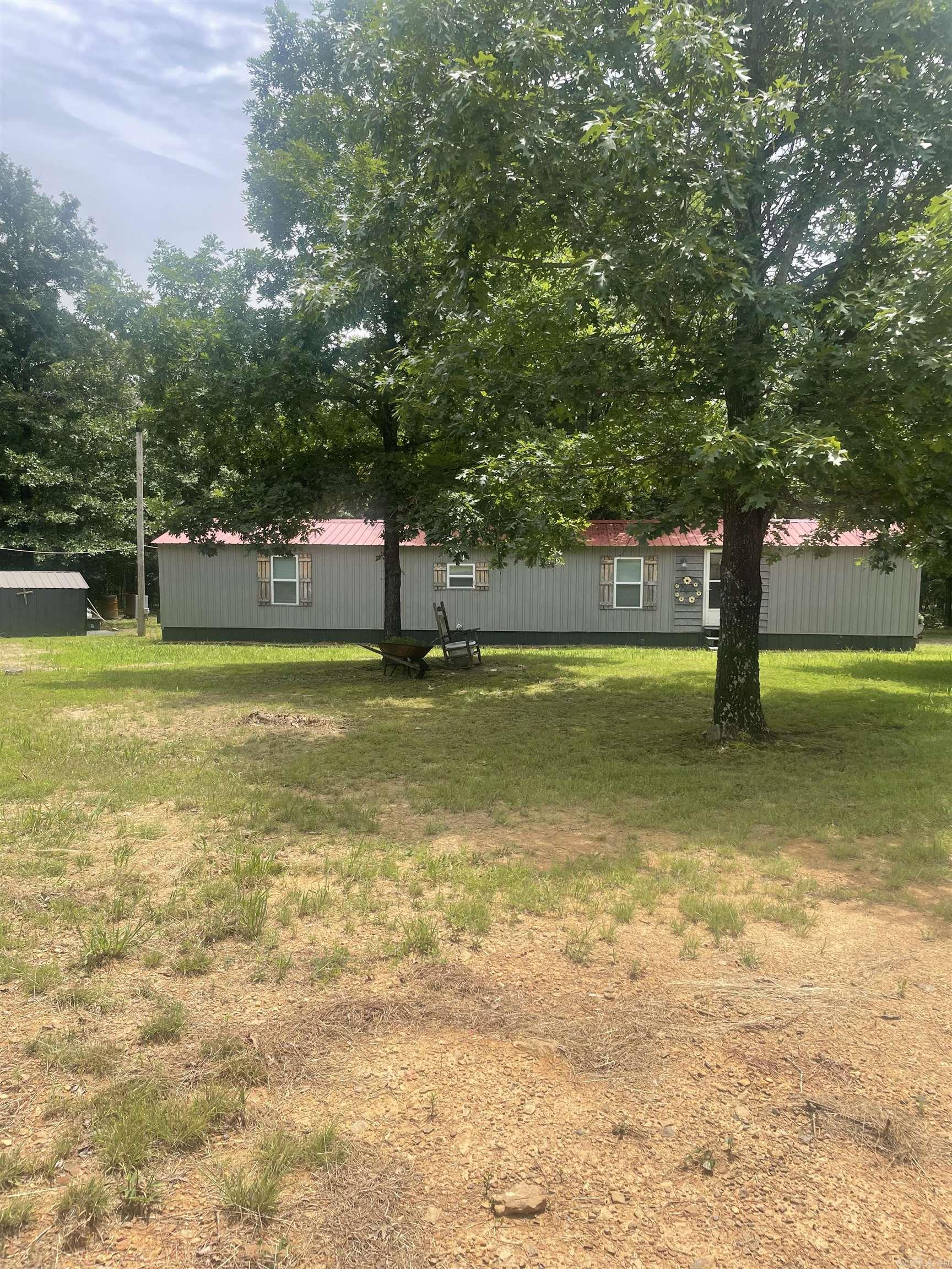 This charming home sets on 1.21 acres.  The entire home has recently been remodeled. It has lament flooring through out and tile in the bathroom. New windows and a 3 1/2 ton Mini Split. You can relax on the back porch and enjoy nature.  Lake access to the Middle Fork of Greers Ferry Lake is only a short distance away. This property has two outside storage buildings. (Bonded Title has been applied For.)