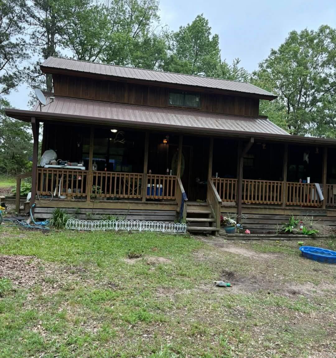 Two story cedar cabin with interior knotty pine walls & cabinets, over 2000sf with wrap-around porch, deck, metal roof, on 6.74 acres, a red 40x32 shop with roll up door, additional 32x30 covered space on back of shop. Close to both Millwood Lake & Lake Greeson, nearby Crater of Diamonds. Country living at it's best! More pictures to be added...