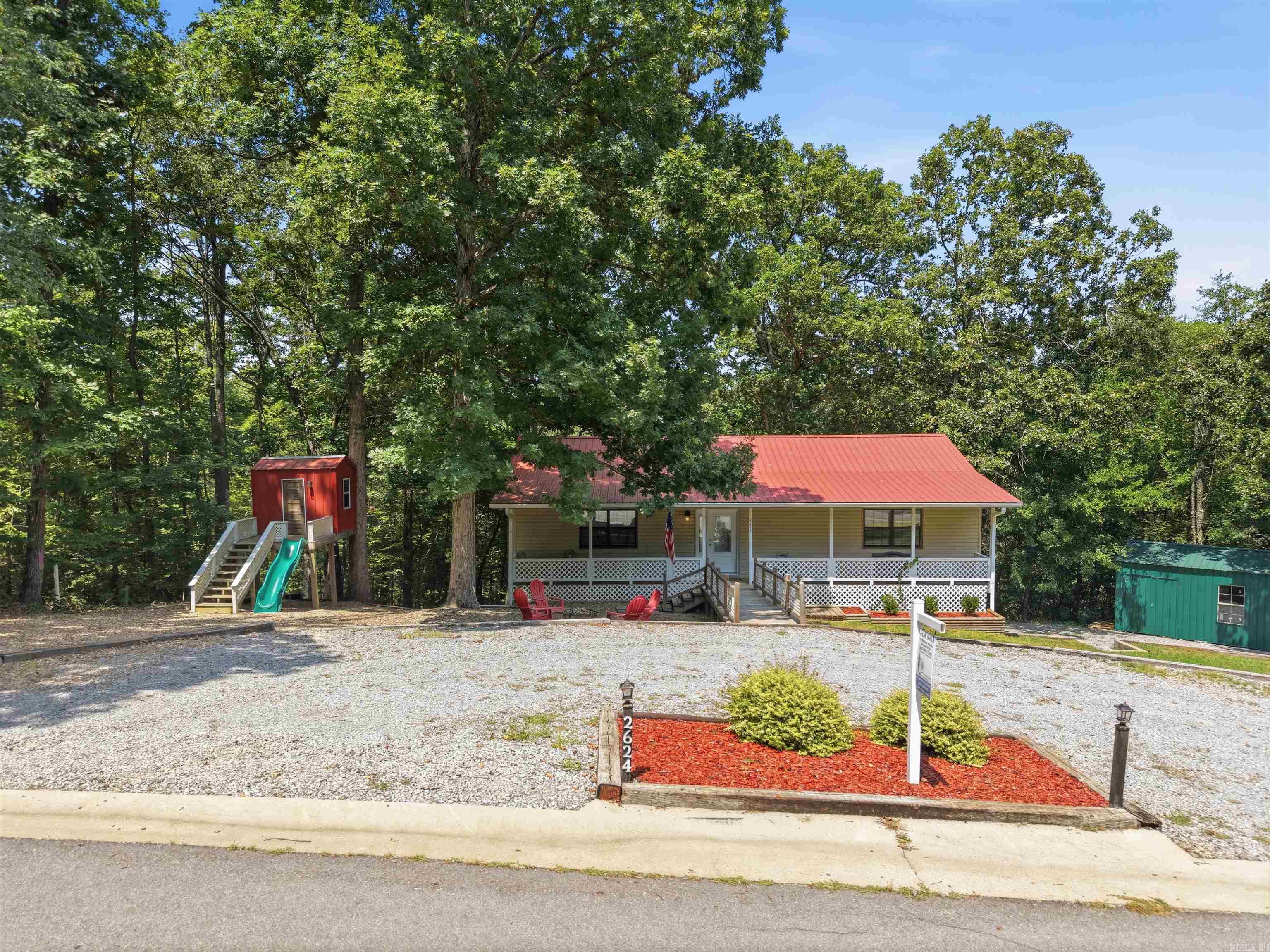 Tucked among mature trees on just over an acre, this inviting home offers the perfect blend of peaceful country living and everyday convenience. A welcoming front porch sets the stage for quiet mornings with coffee or relaxing evenings surrounded by nature. Inside, you'll find an open living area with luxury vinyl flooring, an eat-in kitchen with a breakfast bar, and a functional layout featuring the primary bedroom on the main level with two additional bedrooms nearby. The finished walk-out basement provides flexible space for a second living area, game room, home office, or hobbies. Step outside to enjoy the deck overlooking the wooded property, plus an outside storage building and an oversized two-car garage with plenty of room for vehicles and projects. Located just minutes from Benton, this home offers the privacy and space you've been looking for while keeping shopping, dining, and everyday conveniences within easy reach.