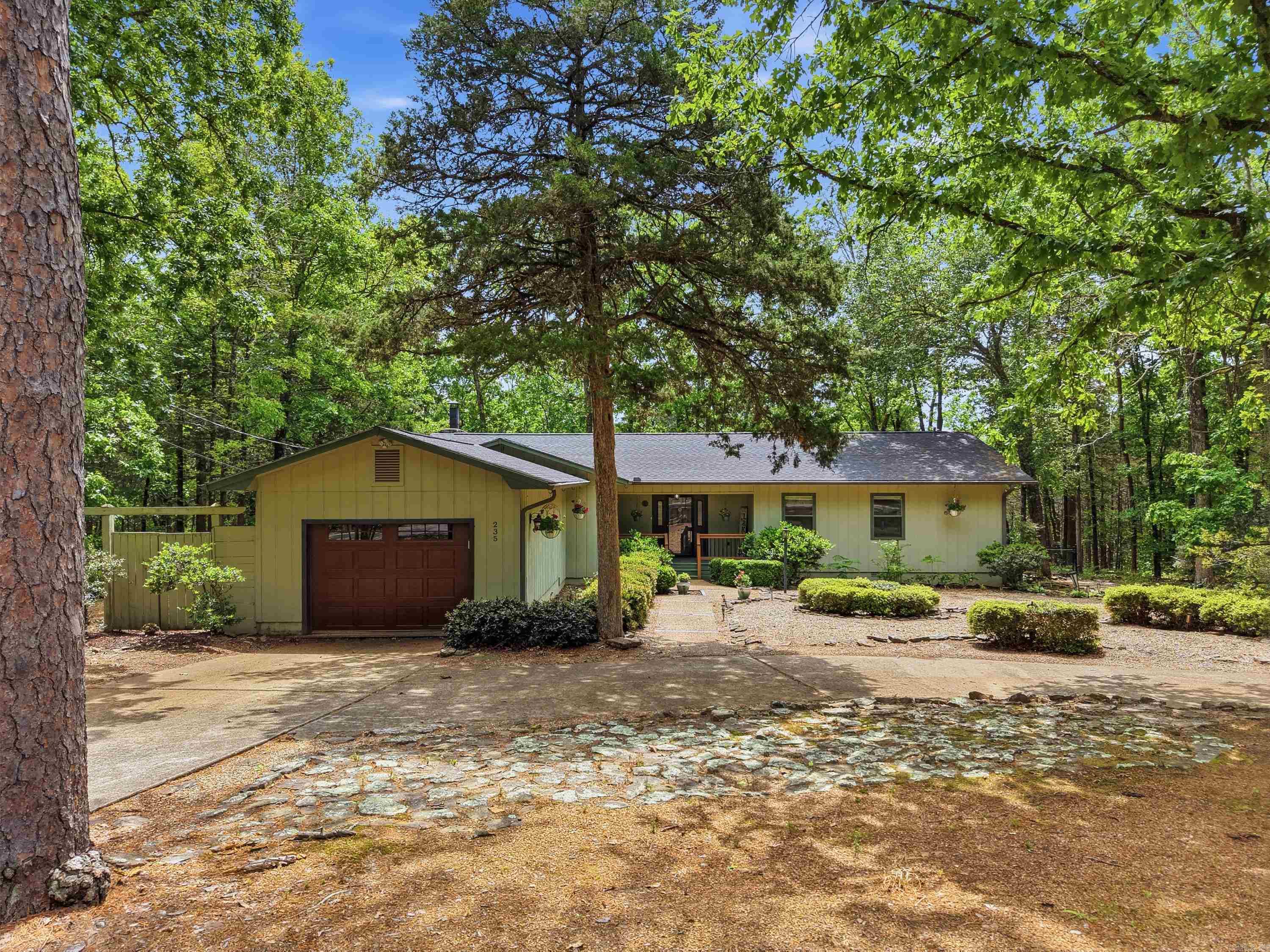 Welcome to your peaceful retreat in beautiful Fairfield Bay! Nestled among the trees on a quiet street, this beautifully updated home sits on over an acre and offers privacy with easy access to outdoor recreation—just minutes from Tee Pee boat launch and Greers Ferry Lake. Inside, you’ll find tasteful updates including granite countertops, newer appliances, high-end refrigerator, updated flooring, and refreshed bathrooms. The spacious layout features large walk-in closets, a cozy stone fireplace, and a heated and cooled sunroom overlooking the wooded backdrop. Enjoy outdoor living with a screened-in porch, perfect for entertaining. A fenced area is ideal for pets, plus a storage building adds convenience. With a new roof in 2022 and numerous updates throughout, including a new insulated garage overhead door. This move-in-ready home is perfect as a full-time residence or weekend getaway in one of Arkansas’s premier lake communities. Residents enjoy golf, hiking, biking trails, atv/utv trails, marina access, and resort-style amenities Fairfield Bay is known for, making this a true escape with everyday comfort. Option to purchase some furnishings. See Agent remarks for updates.