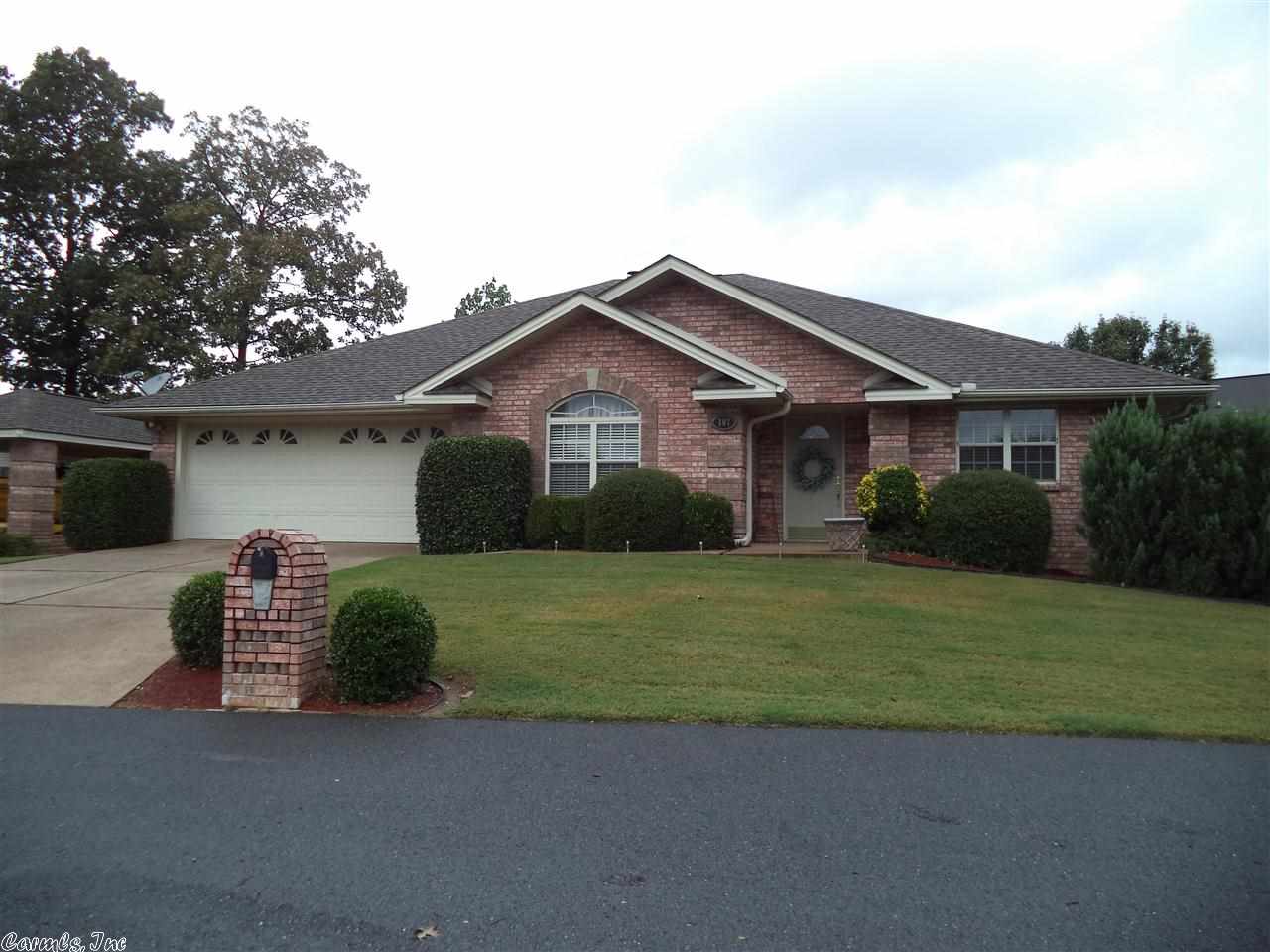 This split open floor plan features hardwood floors, fireplace, wonderful kitchen with dining area, spacious family room, a covered patio with a Lake Hamilton view and LAKE ACCESS,, there are also boat dock which can be leased,, privacy fencing,, storage room plus a separate covered storage for a car or boat ,double garage,,,on a level lot, this is a must see,, has been very well maintained.