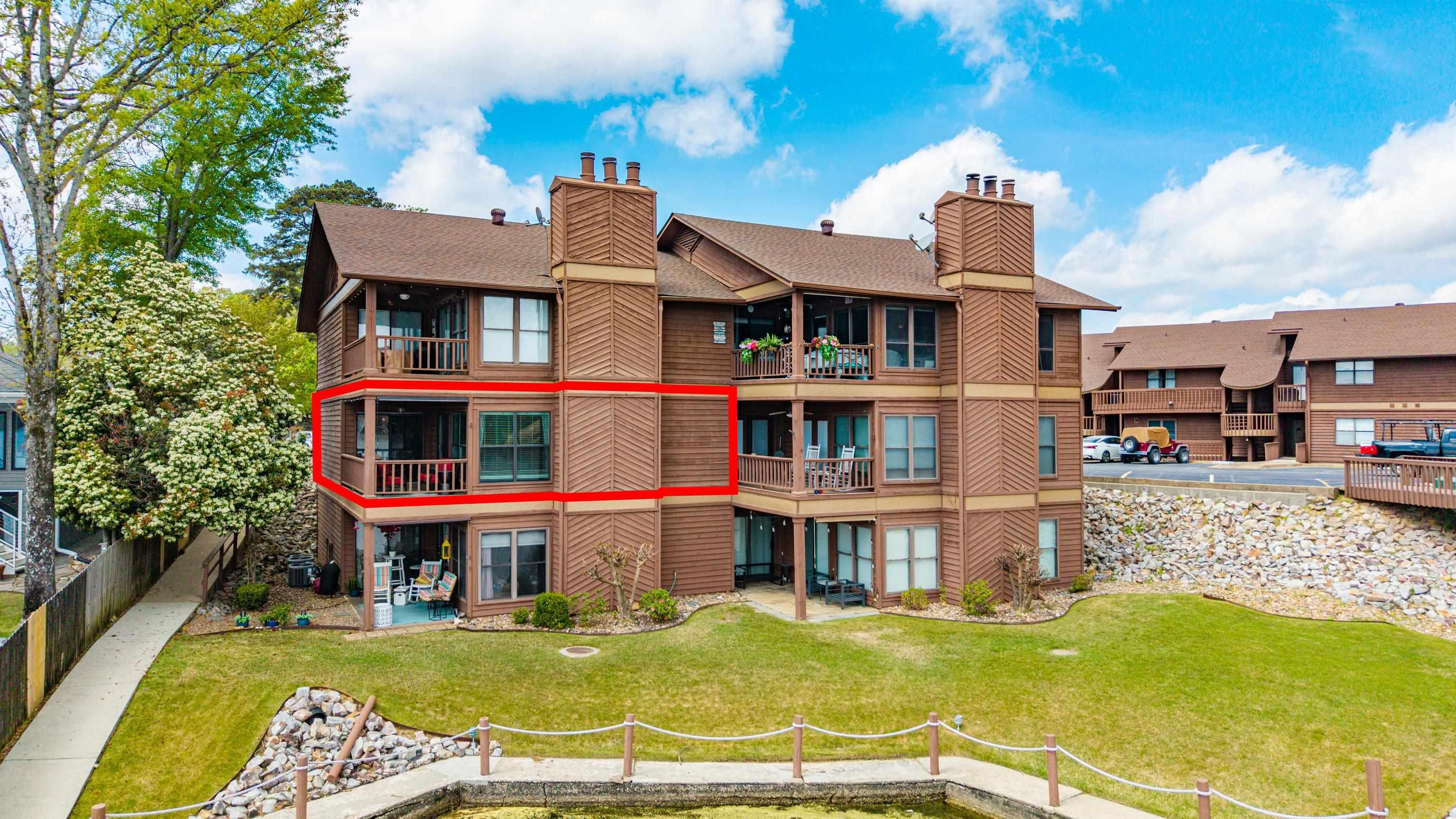 TOTAL UPDATE, PERFECT UNOBSTRUCTED VIEW OF LAKE HAMILTON, PERFECT LOCATION OFF 7 SOUTH. Turn onto Lakeland Drive (halfway between WALMART and KROGER....location  doesn't get any better than this!) Unit A-3 is WALK IN LEVEL.  2 BR 2 BA in established complex with gated entrance, pool, and NO SHORT TERM RENTALS ALLOWED. No carpet. Comes with COVERED BOAT SLIP WITH LIFT and JET SKI DOCK. Patio faces east to enjoy beautiful sunrises over the water and late afternoon grilling in the shade! Reserved parking right at your front door...no steps! This unit accomodates full size washer and dryer. Electric fireplace. New dishwasher. Newer HVAC , ROOF, AND WINDOWS.  Community pool is getting a facelift as well! AGENTS SEE REMARKS