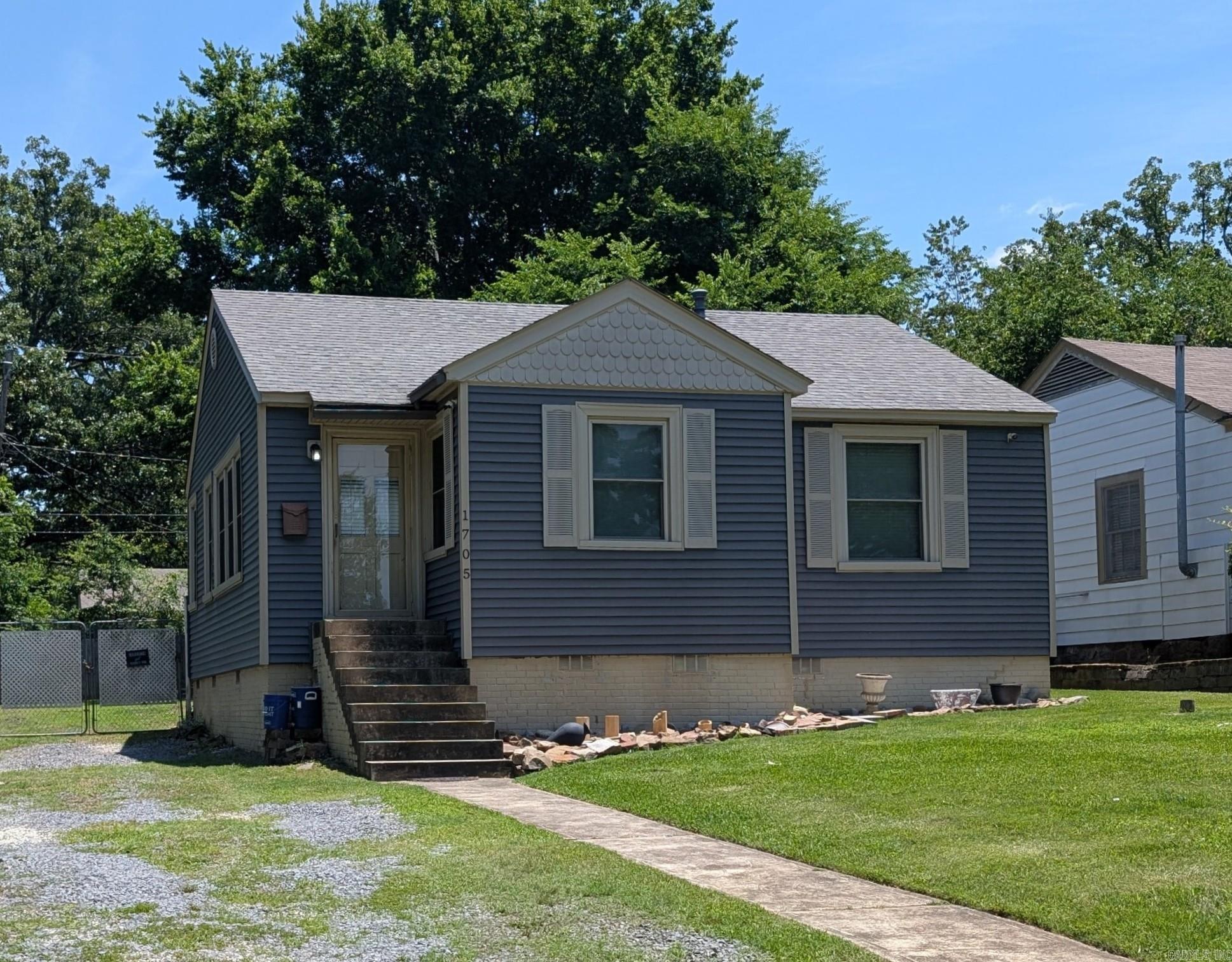 Priced to sell. 2 bedroom 1 bath with dining room, large living room and sunroom. Central heat and air. Original hardwood floors throughout. Large fenced backyard with drive thru gate. Gas range, refrigerator and stack washer/dryer convey.  Low maintenance exterior with Certianteed Vinyl Siding and Alliance Windows.  New tankless water heater - 2026. Owner occupied for last 20 years. No sign on property. Selling "as is".