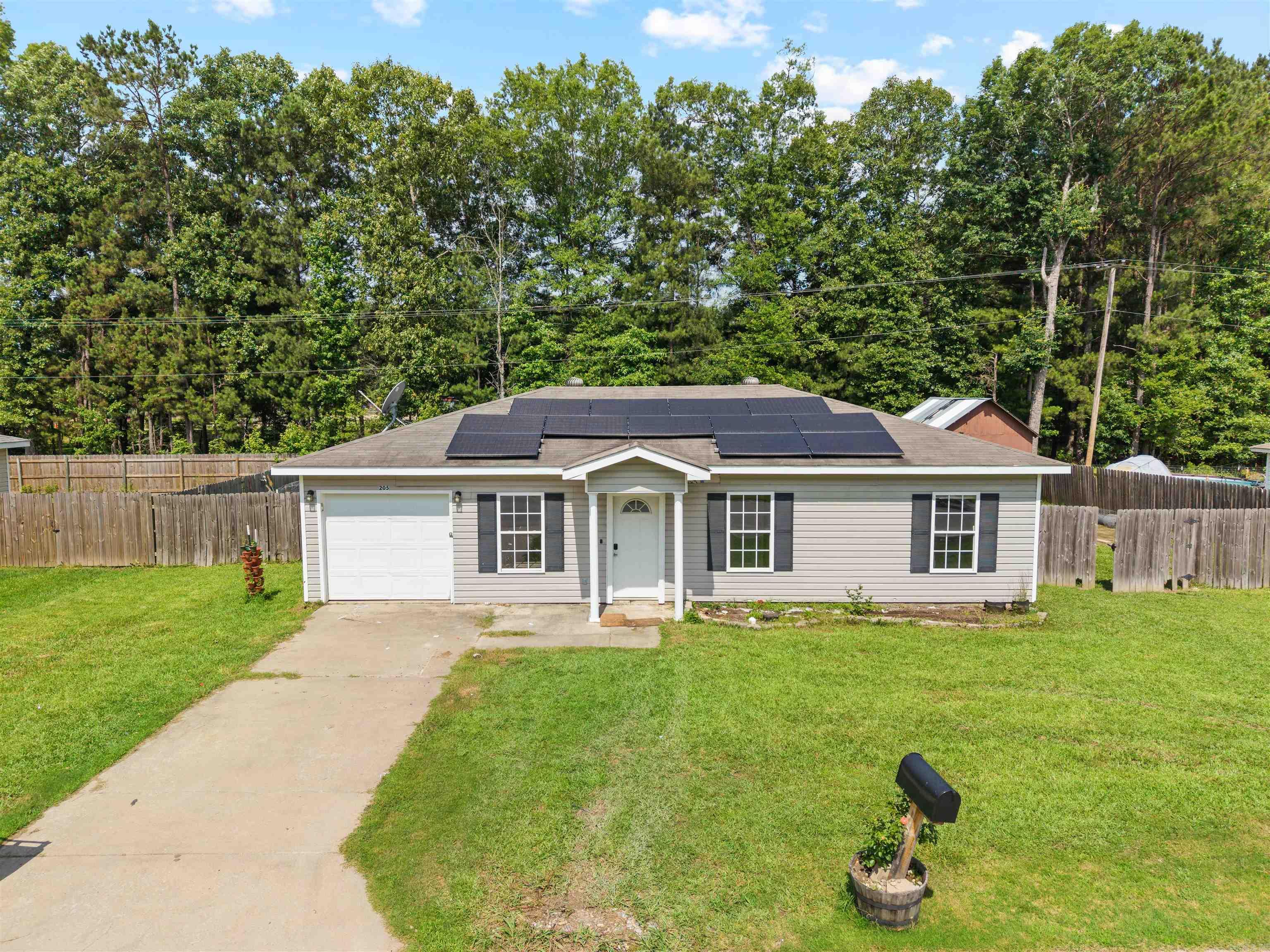 Just 5 minutes away from Harmony Grove School district, with a garden, chicken coop, and solar panels that convey, this is one you do NOT want to miss!  The front door leads you into your living room with undated LVP flooring, new fixtures, and a perfect window letting in natural light.  Connected to your living room is the kitchen, with a fridge that conveys, and a dine in area adjacent. Don’t miss the private full bathroom too! Down the hall you’ve got your bedrooms, clean, and move in ready. Your owners suite features the perfect private bath Chicken Coops and the garden area make you self sufficient the solar panels keep you energy efficient