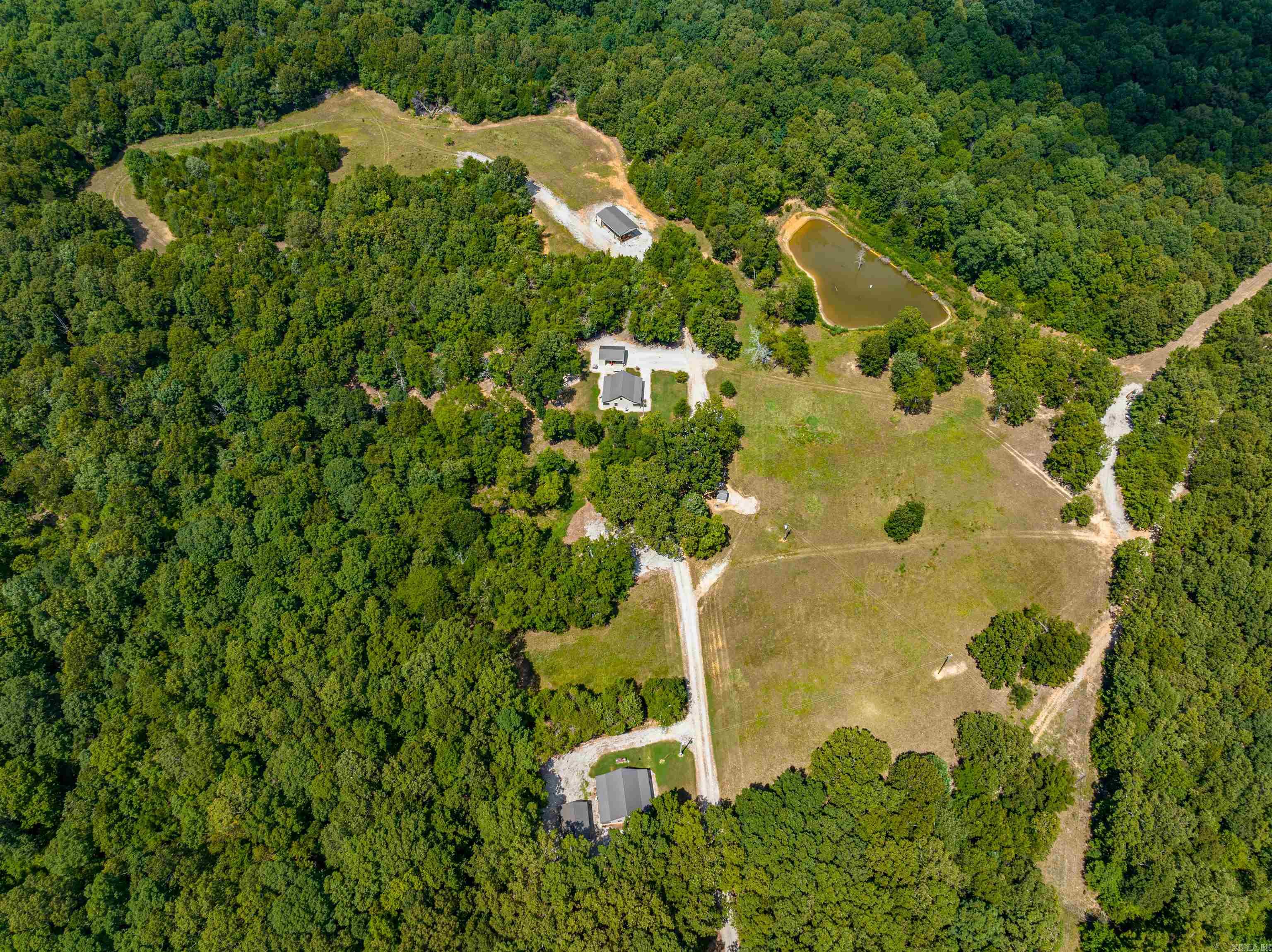 Turn-key Hunting Operation, bring your hunting equipment ready to start enjoying your game-rich property!We offer 1930 +/- Acres, which are all wooded except for a few well-placed food plots and ponds.The property is one of the largest privately owned contiguous timber tracts in the Central Ozarks, with 7 ponds, several springs, deer stands & feeders, a perimeter fire lane, Cabins, and 35 miles of interior roads and trails, all behind locked gates 3 very nice cabins on the property can accommodate 10-15 people.  Each cabin also has a storage shed, and 2 have a carport with outdoor space.  There is a walk-in cooler for all your game after the hunt.  There is also a skinning rack located beside the cooler.  Across the driveway is the well shed, which runs water to all cabins.  Down at the end, there is also a machine shed that houses a John Deere 5606, cabbed tractor, 4 wheel drive with attachments, and a Case 650K, cabbed bulldozer that will all stay with the property as a packaged deal, and there is a storage shed attached as well.