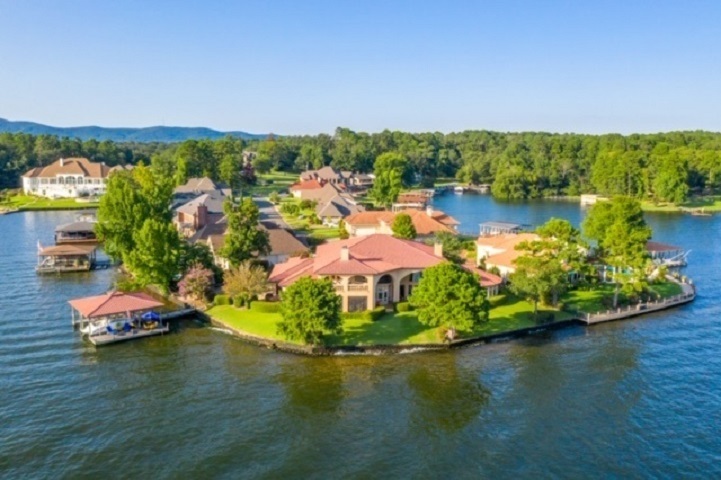 BEST VIEW ON THE LAKE!  7383 sqft 5/5/3 lake home. Located on a level point lot with 260' of lake frontage. Open living concept w/ exceptional lake views of the main channel. Beautiful craftsmanship throughout, custom cabinets, granite, crown molding, tile, hardwood floors in living room and carpet in bedroom. This two story home has an elevator, 1st and 2nd level laundry room & two master baths, each with separate closets.