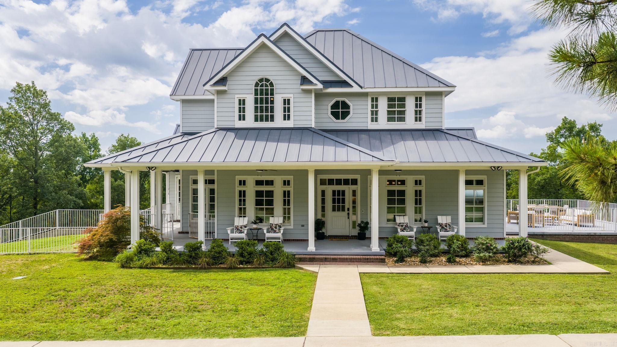 This custom-built retreat overlooking Williams Lake offers the perfect blend of luxury, privacy, and quality construction on 10 beautiful acres in Vilonia. Built in 2018 and surrounded by mature trees, the home features breathtaking views and direct lake frontage. The walkout basement was constructed using an Insulated Concrete Form (ICF) foundation system with reinforced concrete walls, providing exceptional durability and energy efficiency. From the moment you arrive through the private automatic gate, you'll appreciate the thoughtful design and craftsmanship throughout. The main level features a spacious living room, formal dining room, eat-in kitchen with walk-in pantry, and a large private primary suite. Upstairs offers two guest bedrooms connected by a Jack-and-Jill bath with 2 vanities. The basement is ideal for multigenerational living or a private in-law suite, with a full second kitchen, additional living and dining areas, a large bedroom, and full bath. The lower-level living area would also make an excellent theater or rec room. Additional features include a safe room, oversized storage room, mudroom, laundry room, dog wash station, covered patio, and fenced dog run.