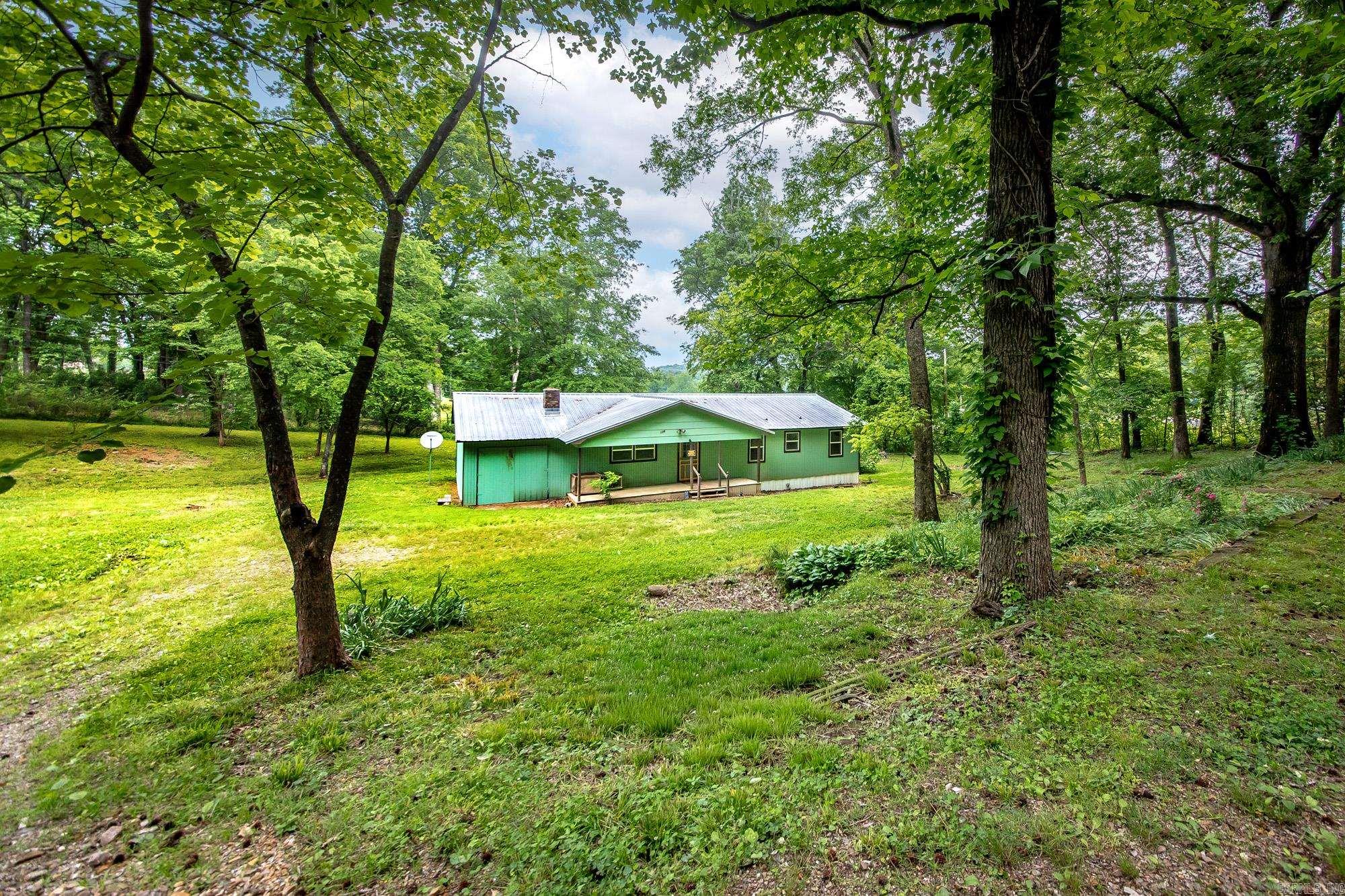 Affordable! Well maintained! Great location! Quiet country living!   Welcome to the "Greenhouse". Sitting on 1 unrestricted acre out of city limits in the sought after Magnet Cove School District. Just 20 minutes from Hot Springs and 10 minutes from I30. This home is in a USDA Rural Development area so ask your lender about zero down!! A solid investment with a NEW metal roof and a completely NEW HVAC system including duct work! Other recent upgrades include: updated plumbing, new floors in primary bathroom and bedroom,fresh paint throughout, new skirting, back porch, and kitchen cabinets.  Enjoy watching the cows graze from your back door, smell the beautiful flowers that bloom every Spring, and pick fresh fruit from your trees. If green isn't your thing, that might can be arranged! Also,this is NOT a mobile home. It is a Jim Walter Site built (think Sears Catalog).   Schedule your showing today, this is a hidden gem ready for your personal touch to make this house your home. AGENTS SEE REMARKS
