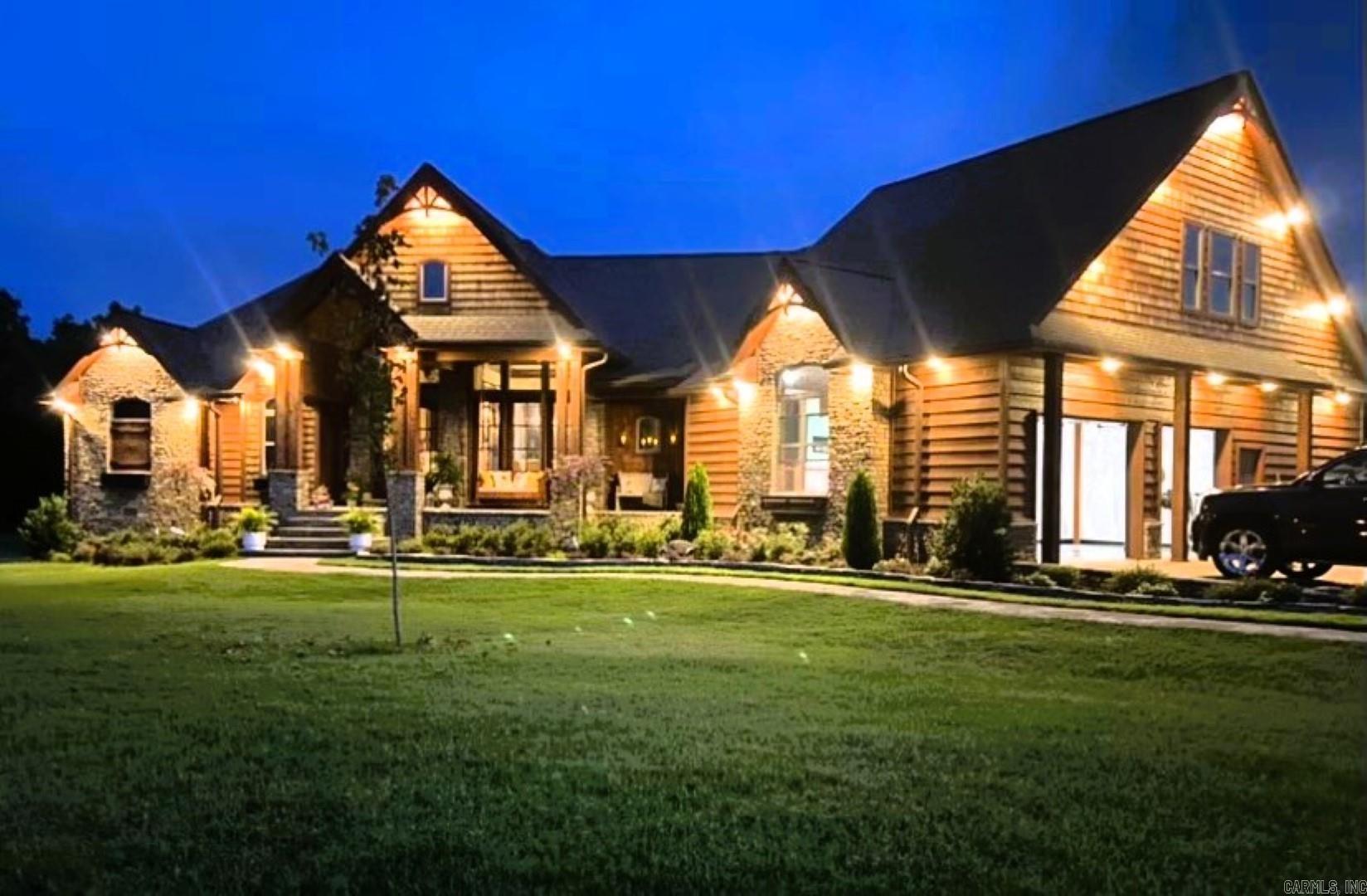 Step into a masterpiece of craftsmanship and comfort at this 4290 sq ft gem, nestled on 1.11 acres at the end of a peaceful cul-de-sac in the prestigious Indian Knob subdivision.  Just 2 minutes from downtown Mountain View, this home blends rustic elegance with modern luxury. Exterior highlights:  Stunning western cedar and native stone facade.  Picturesque exterior lighting enhancing its charm.  Full house generator for peace of mind.  Enclosed porch with an outdoor kitchen, grill, and seated bar for year-round entertaining.  Back deck with composite decking for longevity.  Interior Features: 5 fireplaces, adding warmth and ambiance. Exquisite architectural details, including: A wood barrel ceiling in the family room, an inverted gazebo wood ceiling in the breakfast area, custom built interior doors throughout.  Formal living and dining rooms with soaring 21 ft ceilings and semi-open concept.  A sumptuous master suite with custom tile and woodwork, a walk-in closet featuring detailed wood accents and specialty niches, and a spa-like bath. Central vacuum system for effortless cleaning, two-car garage. 4 bedrooms, 3.5 baths, and so much more.
