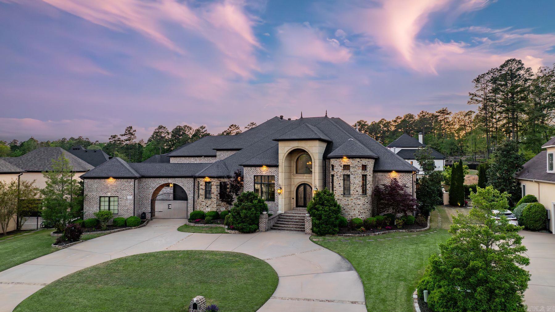 Welcome to 106 Orle, where Tuscan-inspired elegance meets relaxed luxury in one of Chenal’s premier gated neighborhoods. Step into the grand two-story foyer with hand-painted frescos, giving an artistic and warm touch to the living spaces. This chef’s kitchen is made for entertaining,with double islands, premium appliances, and a wet bar.  A private main-level guest suite offers a space for visitors, complete with its own sitting area and ensuite bath. The primary suite features a separate living area perfect for a wellness room, office, or library highlighted with a three-way glass fireplace . A serene spa like bath and dual oversized closets add to the abundance of this suite. Upstairs multiple spaces offer endless possibilities, including two guest suites each with their own ensuite bathroom, a theatre room with a built-in bar, a second private office with an attached covered balcony, and a work out or playroom.  Your private outdoor oasis—with a full kitchen, hot tub, and peaceful fountain is the perfect place to entertain. And for golf lovers, drive your cart directly from your garage to private access of the 18th hole of the Bear Den Course at Chenal Country Club.See remarks