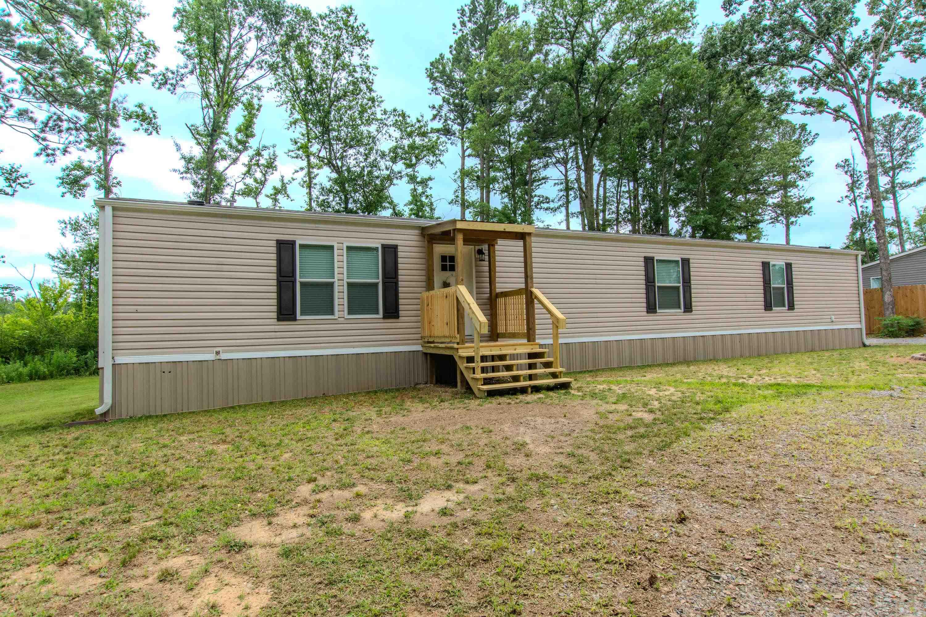 Beautiful, move in ready 3 bed, 2 bath home. Living, dining and kitchen open .  All electric and very affordable utilities  Split bedroom plan. Laundry room convenient to bedrooms. Home is 2 years old but has been freshly painted. 2 x 6" walls.  Sheetrock throughout. Front porch and covered back deck with carport.  9' fence between property and neighbor. Permanent foundation. Septic has been pumped and new field lines and distribution box.  Not in city limits. Refrigerator, washer and dryer convey with acceptable offer.
