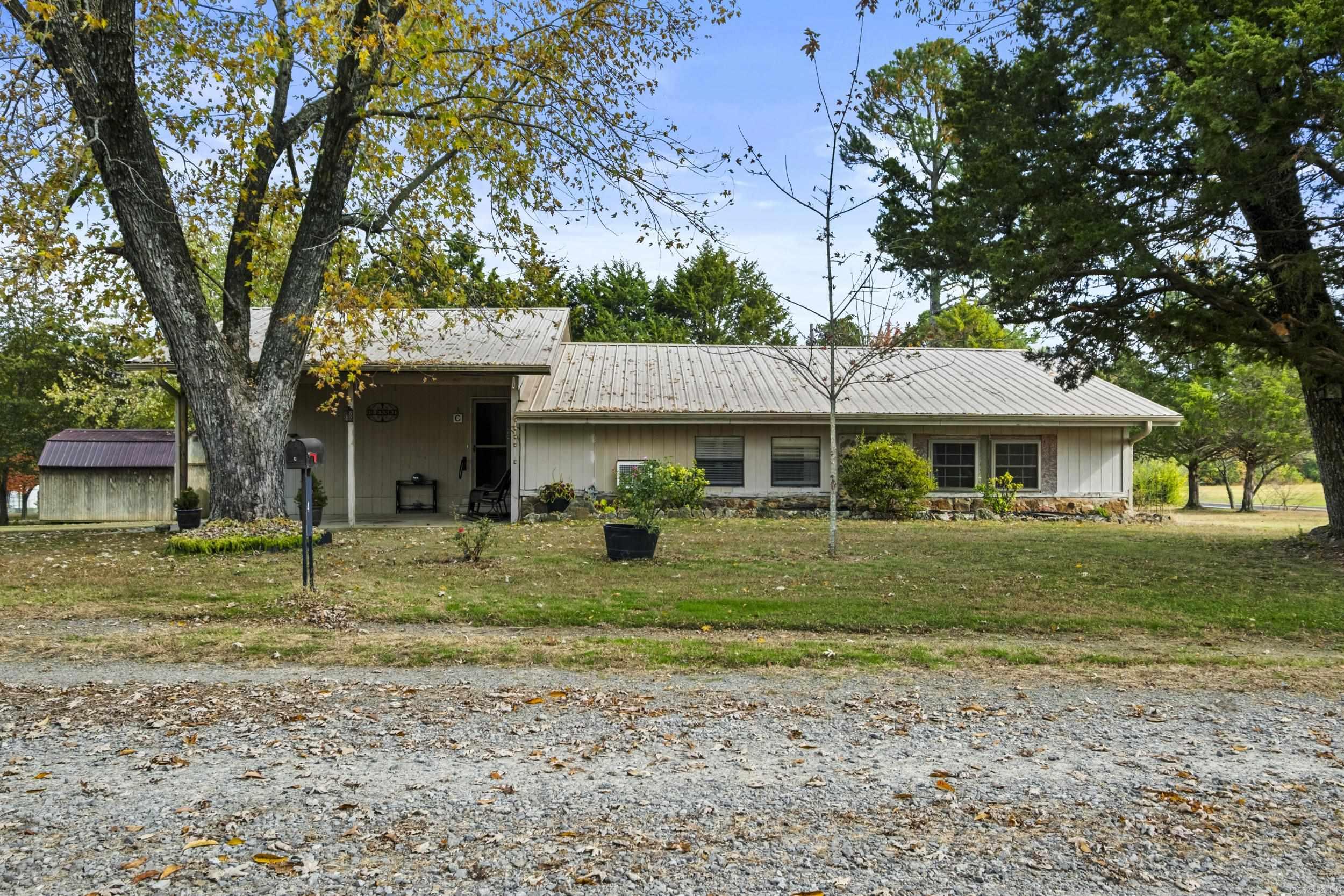 Welcome to 4 Persimmon Lane in Tumbling Shoals. This charming split-level home offers a comfortable layout and peaceful setting just Minutes away from Greers Ferry Lake!! Enjoy peace of mind with a metal roof, storm shelter and multiple outbuildings- perfect for extra storage, hobbies or lake gear. Whether you're looking for a full-time residence or a relaxing weekend getaway, this property offers the perfect blend of comfort, functionality, and lake life living!