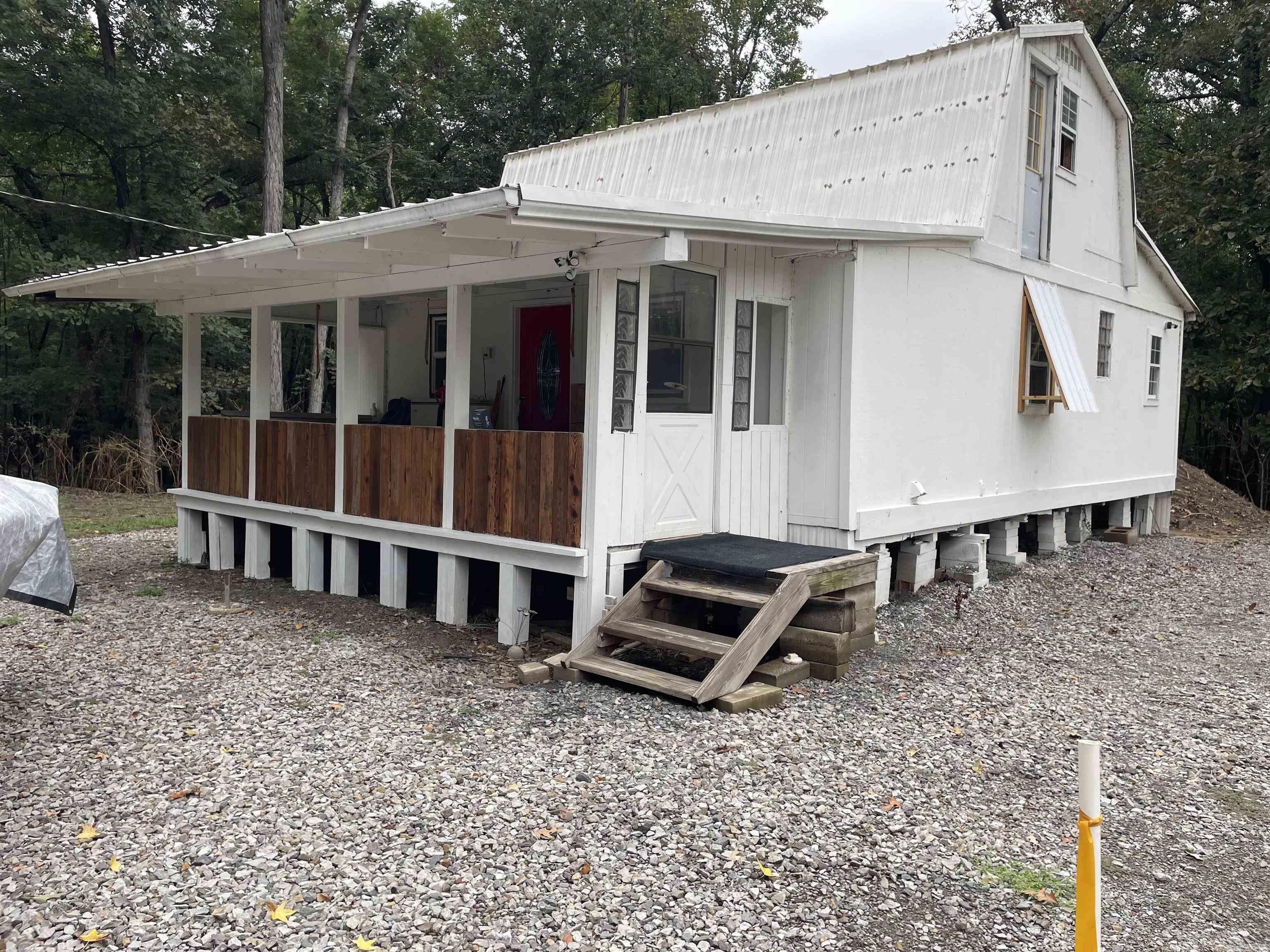 If you're looking for an affordable river retreat, take a look at this! The two cabins are situated on 5 lots in the Nimmo Riverbank Subdivision, just a short walk or ride to the banks of the Little Red River in SE White County. One of the cabins has been a full time residence for the last several years and there are piers ready for you to add on to it to make it even larger for whatever your needs may be. The white cabin is not quite in livable shape (just yet), but it has good bones and is ready for you to make it your own. Thousands of acres of public hunting and fishing land are just minutes away and the Little Red River and White River are right there as well making this a perfect place to make your headquarters for hunting and fishing trips. Both cabins have SEWCO city water and the power is provided by Entergy. The sellers use Starlink internet.