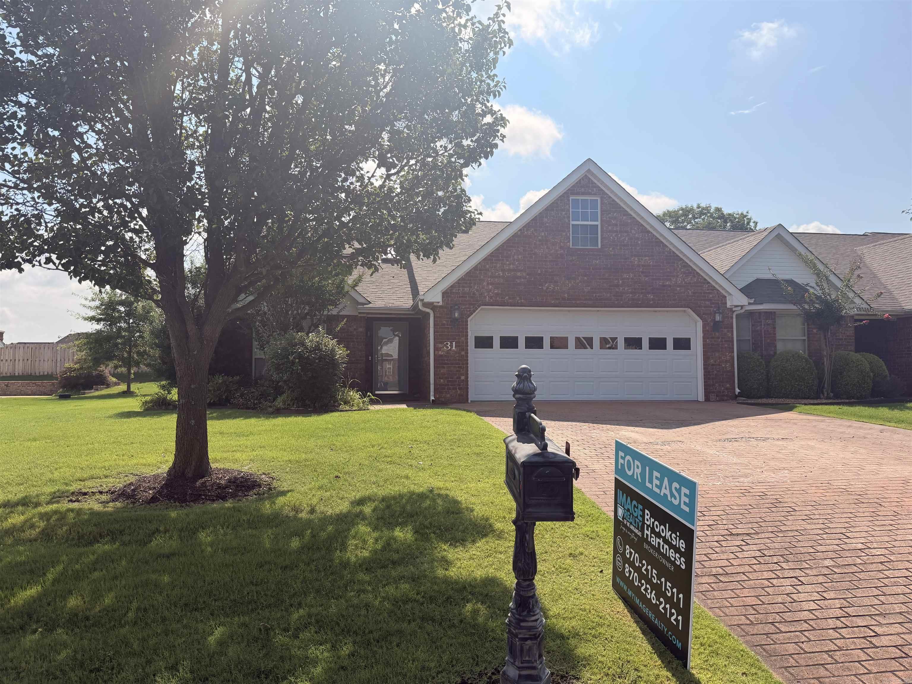 Lease Opportunity in The Enclave. Enjoy beautifully manicured grounds and a peaceful pond with fountain views in this well-maintained 2 bedroom, 2 bath brick condo. The bright great room flows into a dedicated dining area and an all-white kitchen with generous storage. A separate laundry room adds everyday convenience. The primary suite features new flooring and a brand-new custom tiled shower. Relax year-round in the sunroom overlooking the landscaped surroundings. Additional highlights include a double garage, fresh finishes, and easy access to local amenities. Available now with a one-year lease requirement.