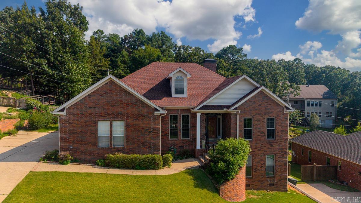 Welcome to life in The Ranch—one of West Little Rock’s most sought-after neighborhoods, offering a private lake for fishing & kayaking, scenic sidewalks, and a community park and playground. Ideally located off Highway 10, this home blends convenience with peaceful living. The main level features the heart of the home with a spacious living room anchored by custom built-ins, a well-appointed kitchen with abundant cabinet and countertop space, a defined dining room, and a beautifully detailed office with rich wood built-ins. The primary suite offers a true retreat with double vanities, two closets, and a spa-like feel. Downstairs, you’ll find two additional bedrooms and a full bath on a separate lower level—perfect for guests, kids, or added privacy. Enjoy stunning views of Pinnacle Mountain from the dining room and office, relax in the light-filled sunroom, or step outside to the multi-level back deck, partially covered for year-round enjoyment. This home offers the perfect blend of space, character, and lifestyle. Agents see remarks.