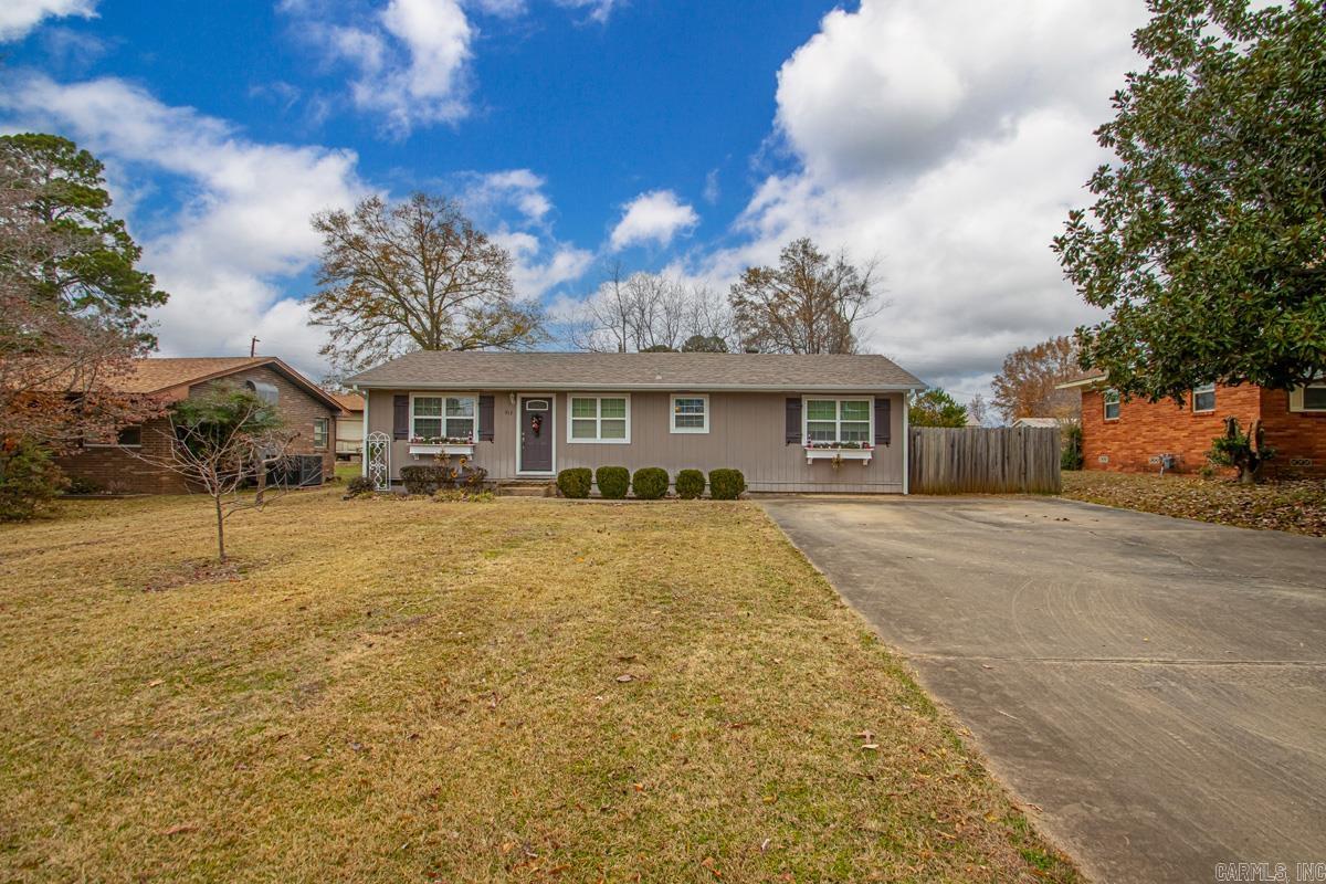 Welcome to this well-maintained and beautifully updated home located at 912 West Vine Street, offering space, character, and convenience all in one. This 3-bedroom, 2.5-bath home is just minutes — and even walking distance — to local schools, with easy access to the bypass. The home blends classic charm with major updates. In 2016, a spacious master bedroom, bath & sunroom addition was completed along with a new roof, creating a comfortable and functional layout. The home offers approximately 1,883 sq ft with a large master suite featuring vinyl plank flooring, a private bath with a separate shower and whirlpool tub. The kitchen is a standout with custom cabinetry, a large island, double ovens, upper cabinet lighting, and a gas cooktop. A cozy den with original wood ceiling adds warmth and character, while a gas fireplace enhances the living room.  More features include: 2.5 bathrooms, two water heaters (one electric dedicated to the master), gas fireplace, gas cooktop, separate laundry room with 1/2 bath, gutters (new) & storage building. This home has been lovingly cared for by the same owner since 94.